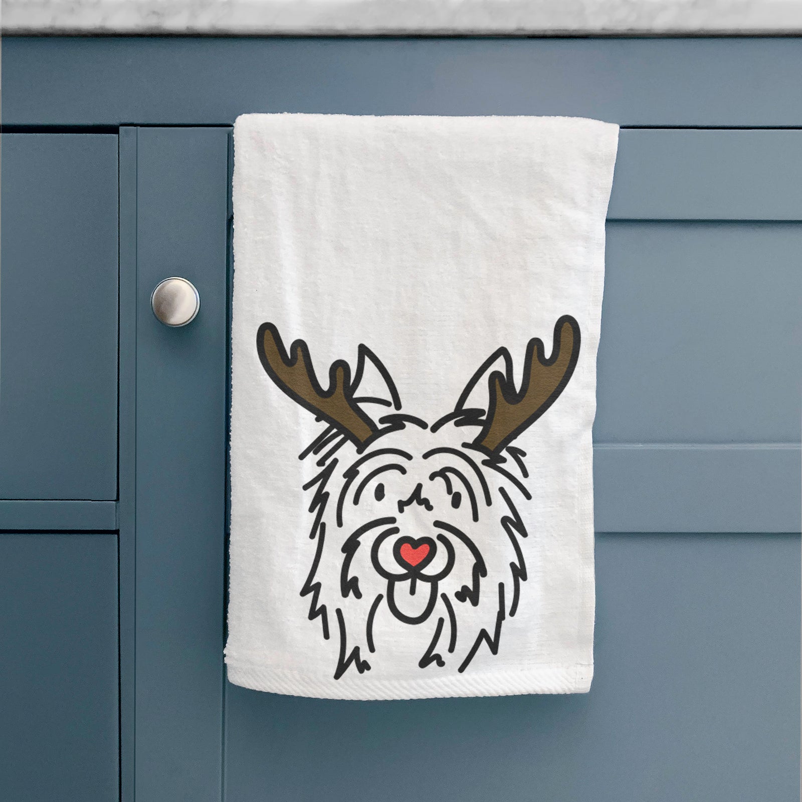 Minimalist line drawing of Monty the Silky Terrier with reindeer antlers and a red nose on a hand towel