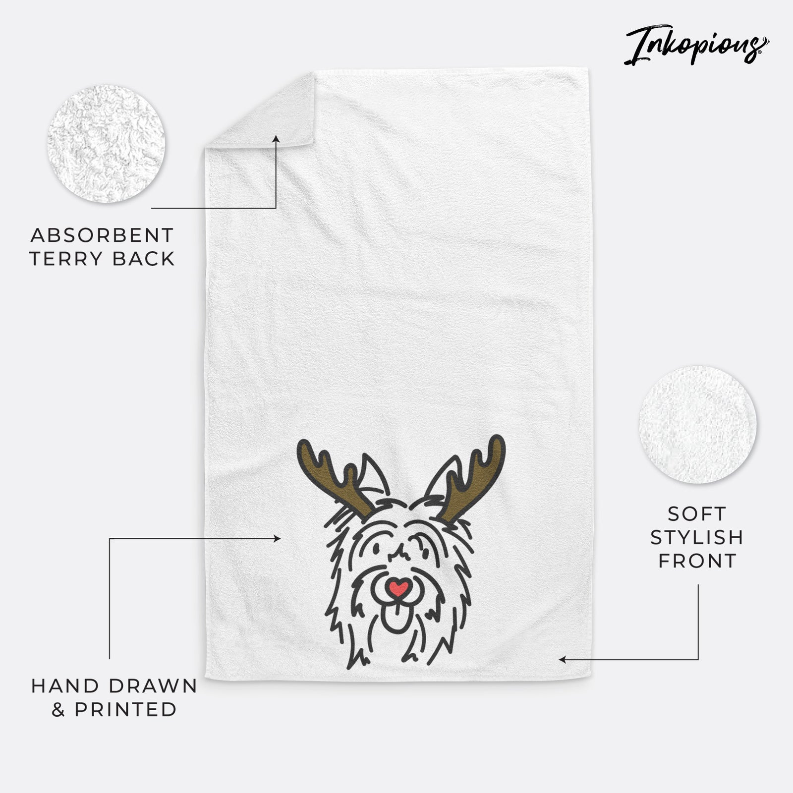 Minimalist line drawing of Monty the Silky Terrier with reindeer antlers and a red nose on a hand towel