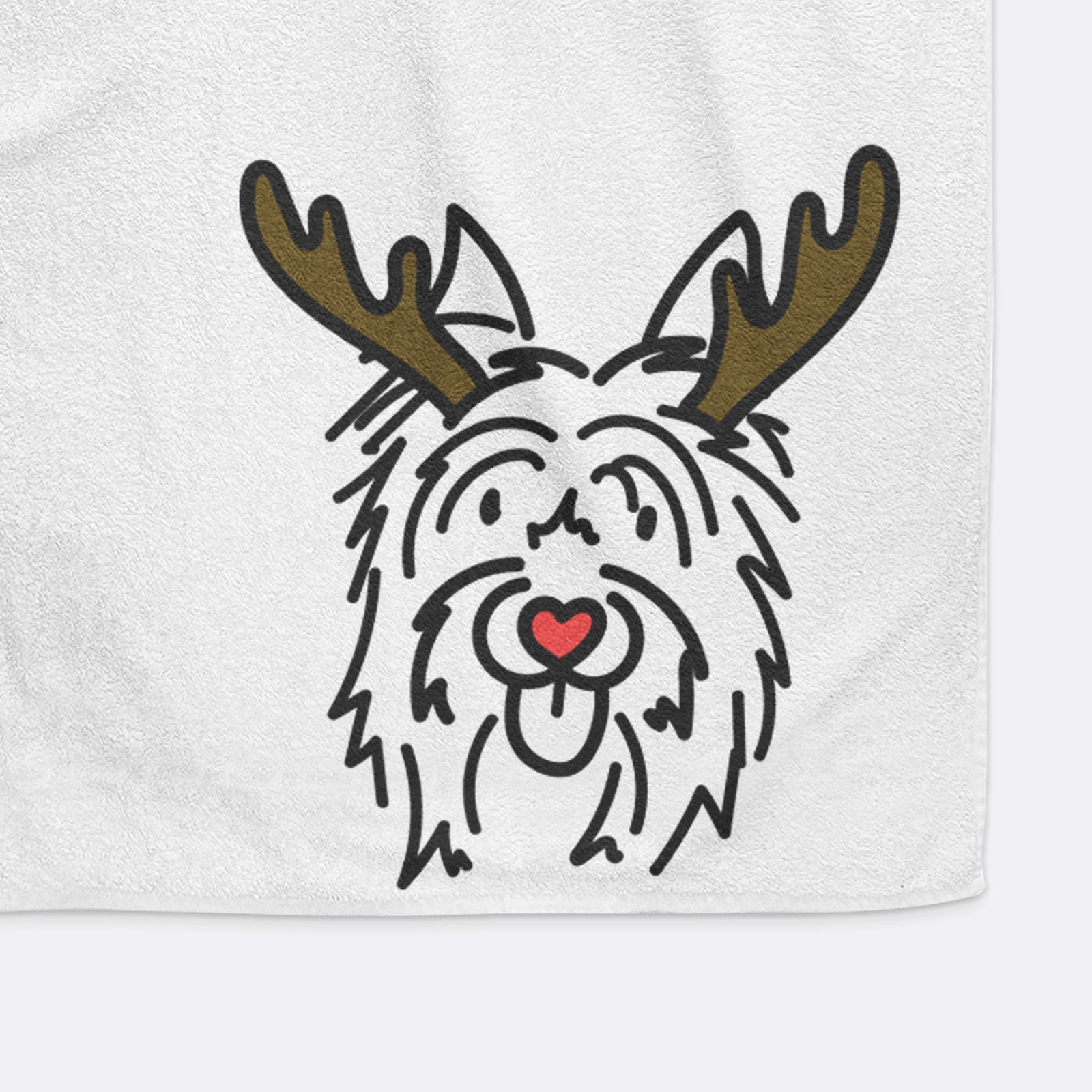Minimalist line drawing of Monty the Silky Terrier with reindeer antlers and a red nose on a hand towel