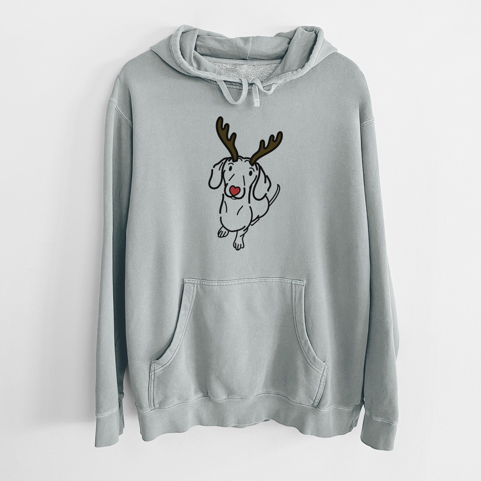 Minimalist line drawing of Moxie the Dachshund with reindeer antlers and a red nose on a Sage Unisex pigment dyed hoodie