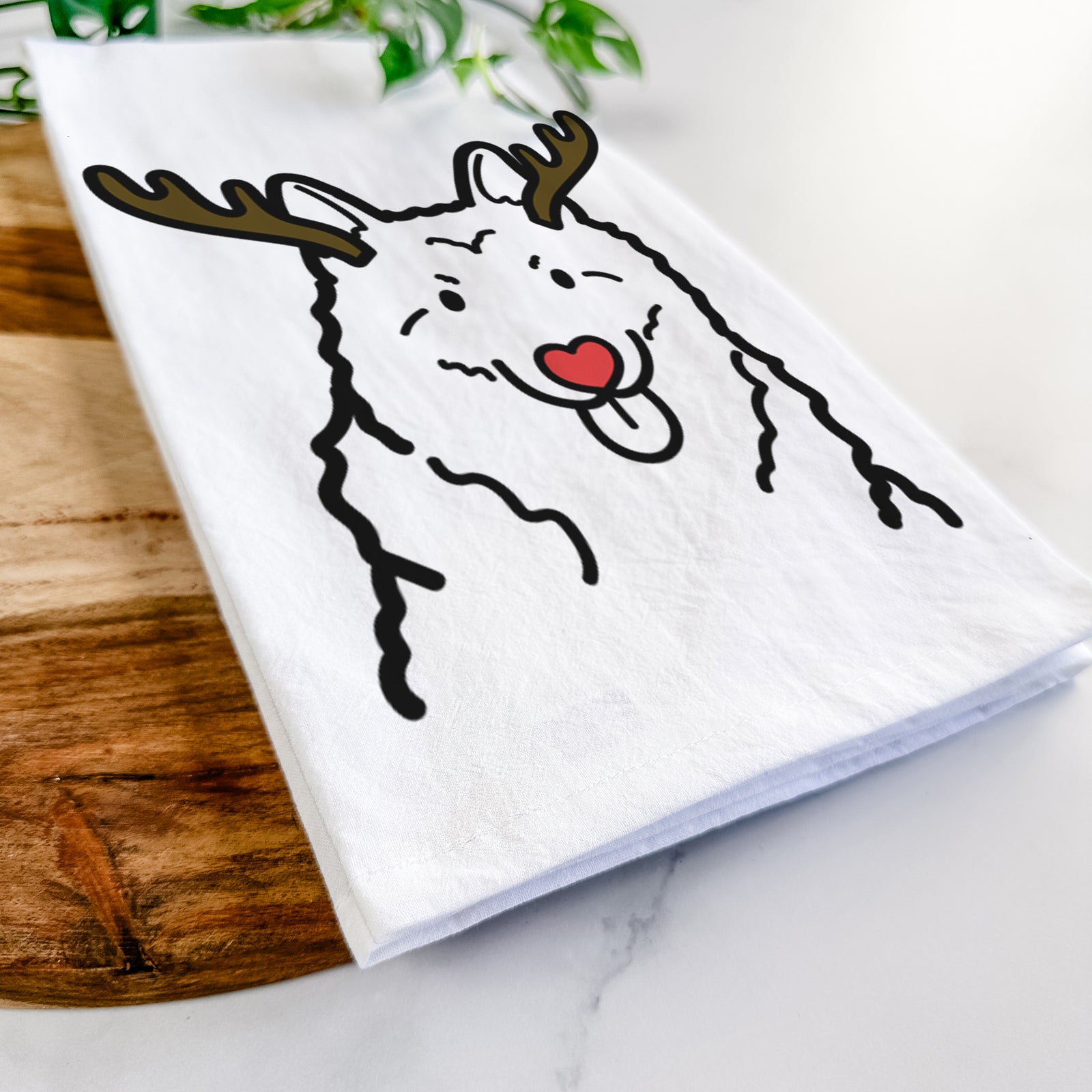 Minimalist line drawing of a Norwegian Elkhound with reindeer antlers and a red nose on a tea towel