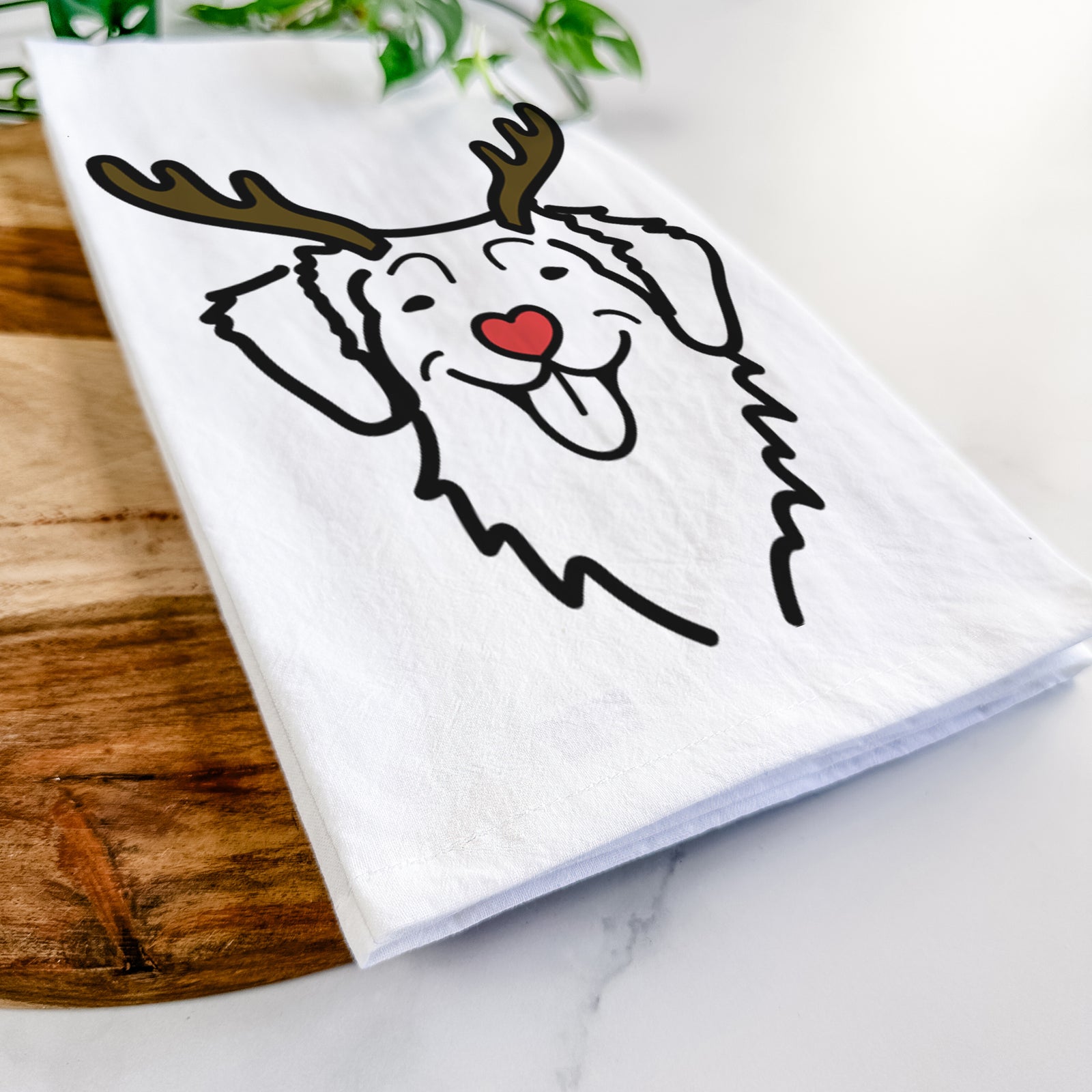 Minimalist line drawing of a Nova Scotia Duck Tolling Retriever with reindeer antlers and a red nose on a tea towel