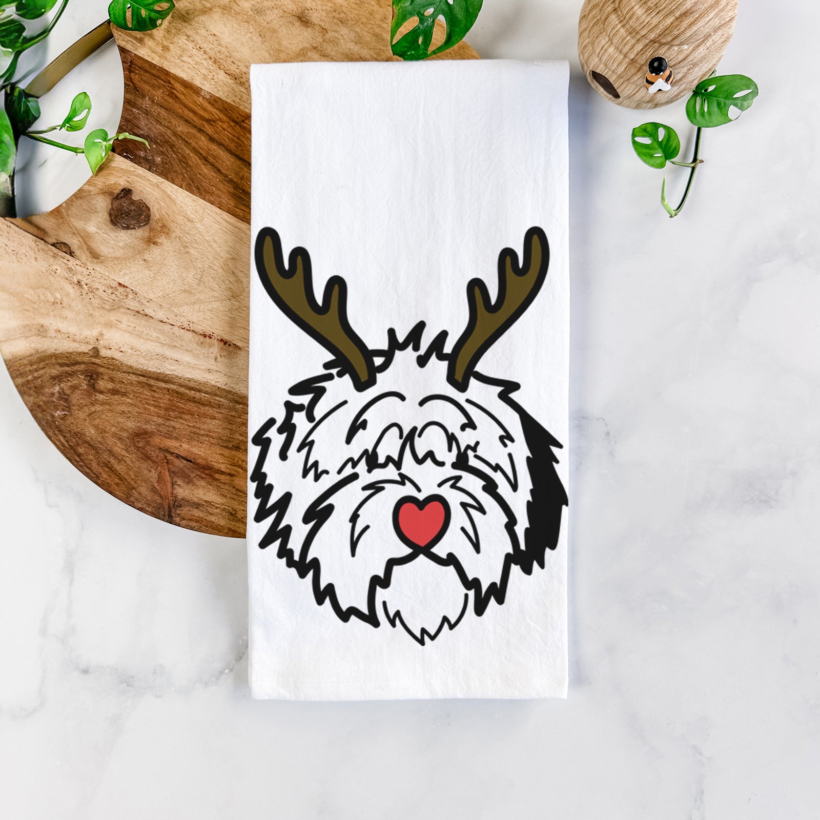 Minimalist line drawing of Penny the Old English Sheepdog with reindeer antlers and a red nose on a tea towel