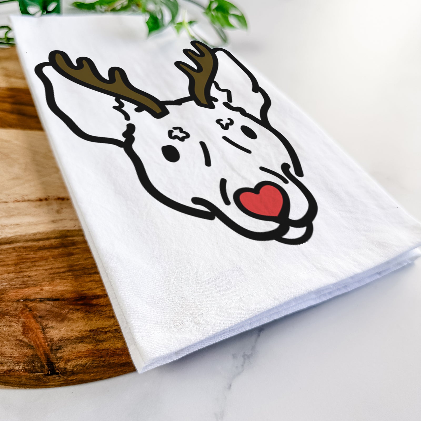 Minimalist line drawing of Penny the Rat Terrier with reindeer antlers and a red nose on a tea towel
