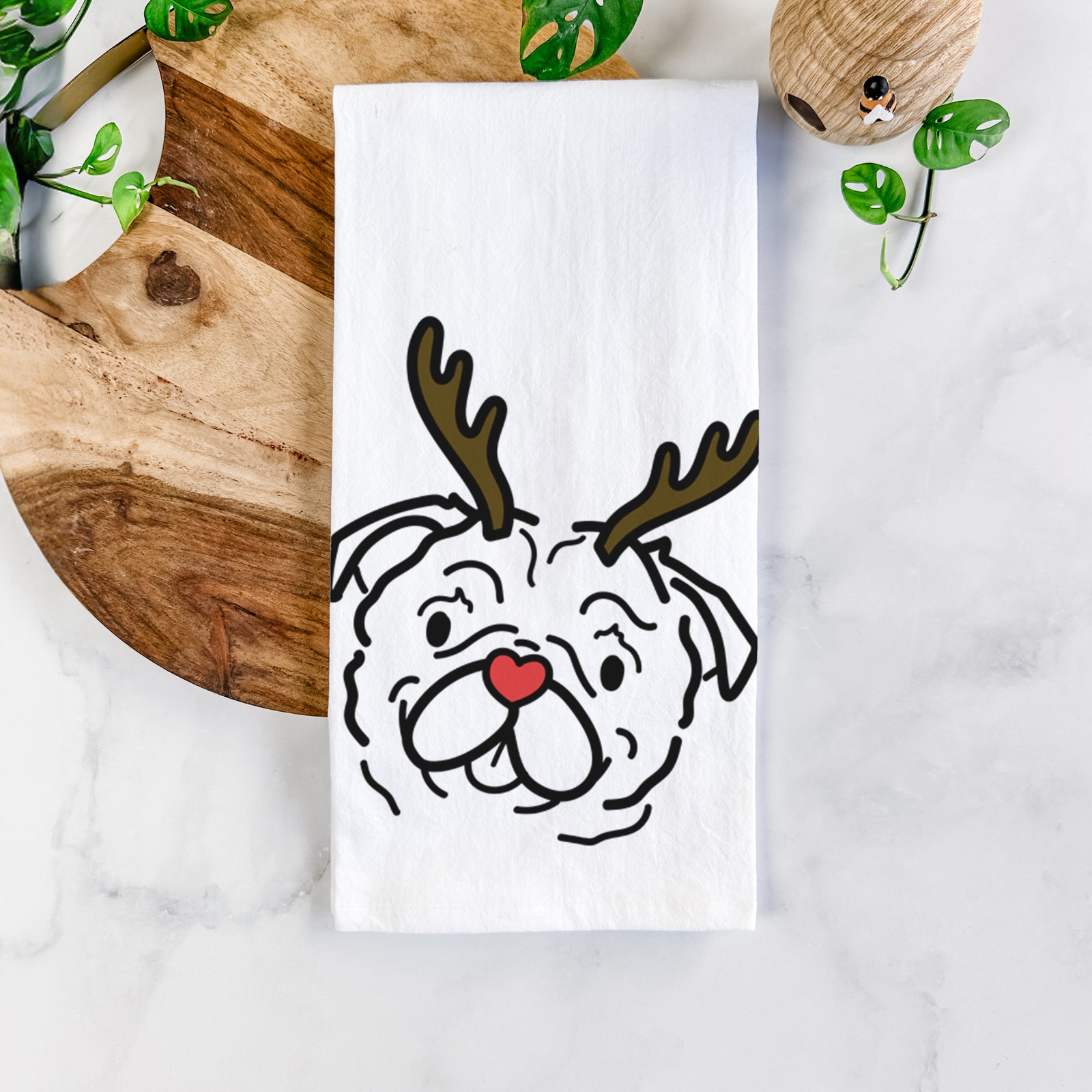 Minimalist line drawing of Pip the Pug with reindeer antlers and a red nose on a tea towel