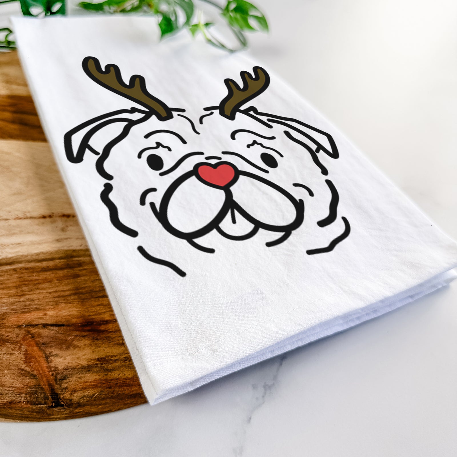 Minimalist line drawing of Pip the Pug with reindeer antlers and a red nose on a tea towel
