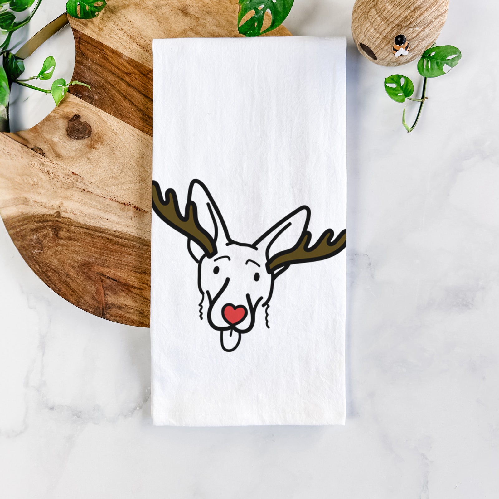 Minimalist line drawing of Rosie the Shepherd Mix with reindeer antlers and a red nose on a tea towel