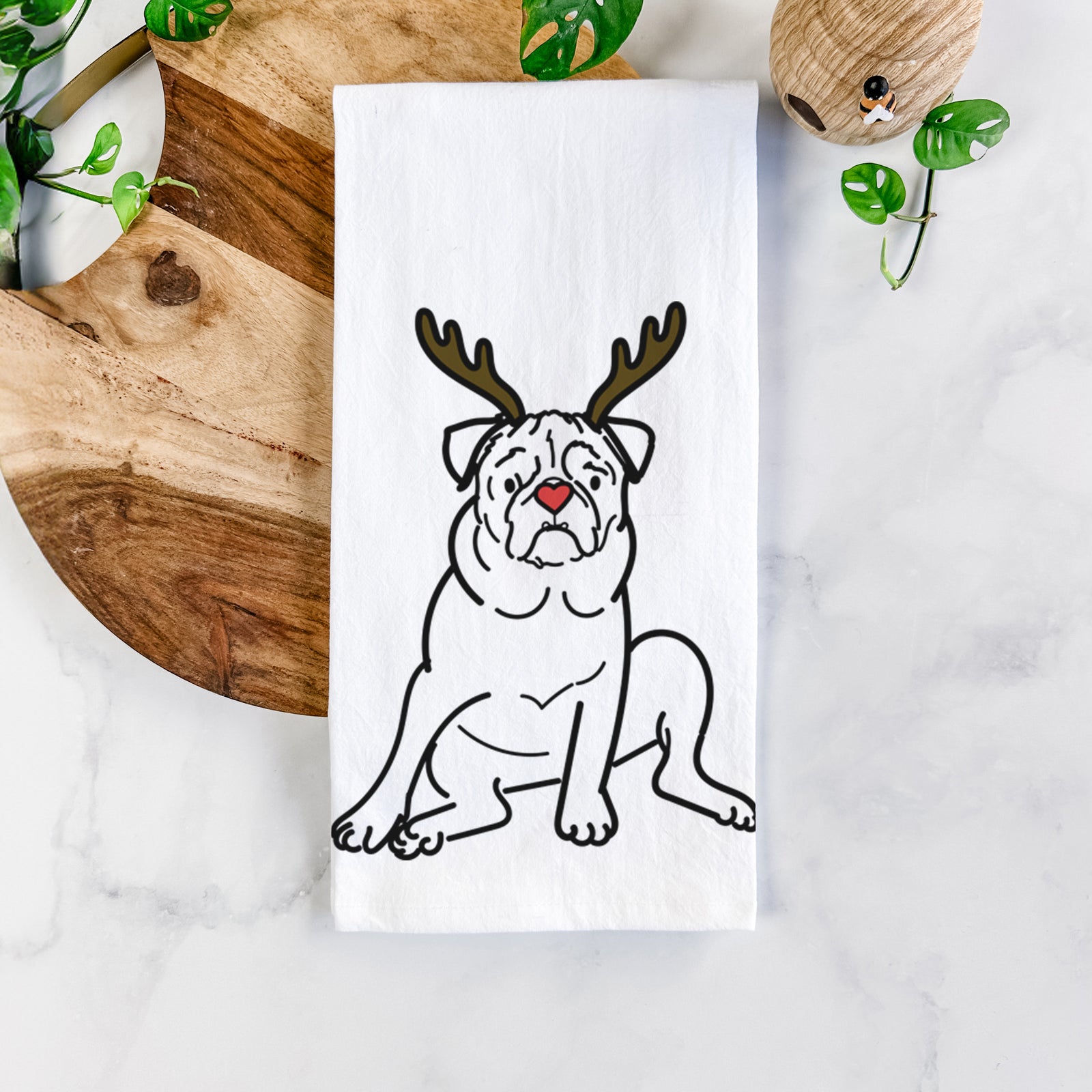 Minimalist line drawing of Rudy the Pug with reindeer antlers and a red nose on a tea towel