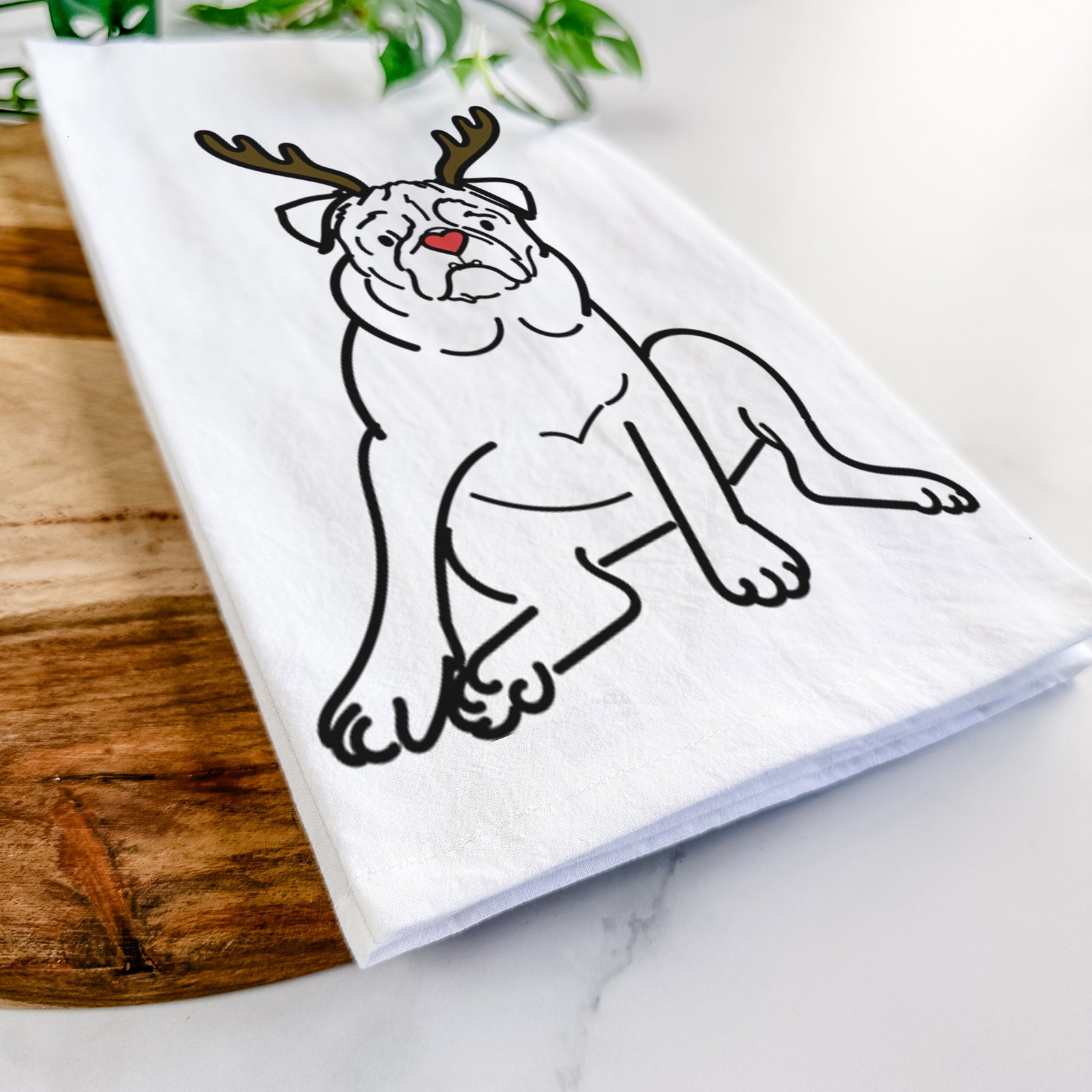 Minimalist line drawing of Rudy the Pug with reindeer antlers and a red nose on a tea towel