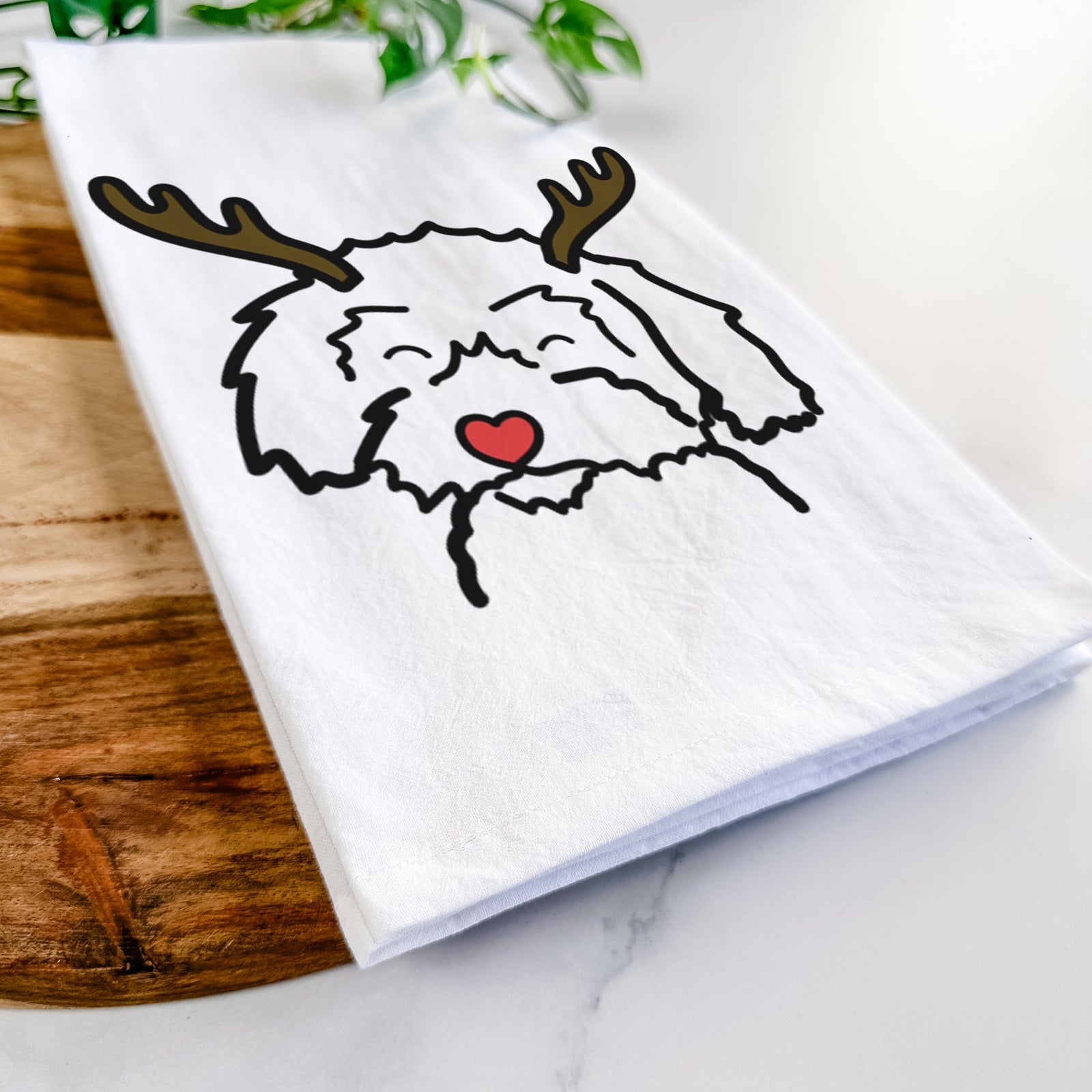 Minimalist line drawing of a Schnoodle with reindeer antlers and a red nose on a tea towel
