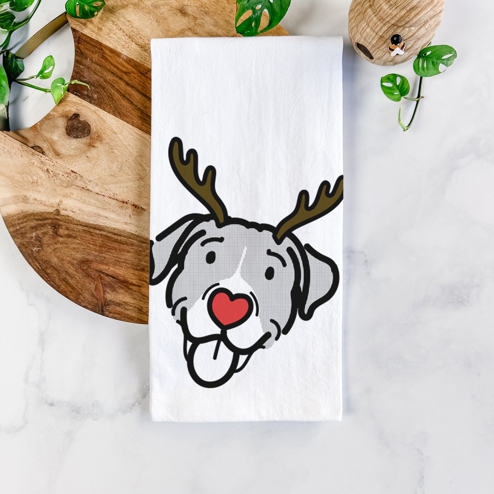 Minimalist line drawing of Shadow the Pitbull Mix with reindeer antlers and a red nose on a tea towel