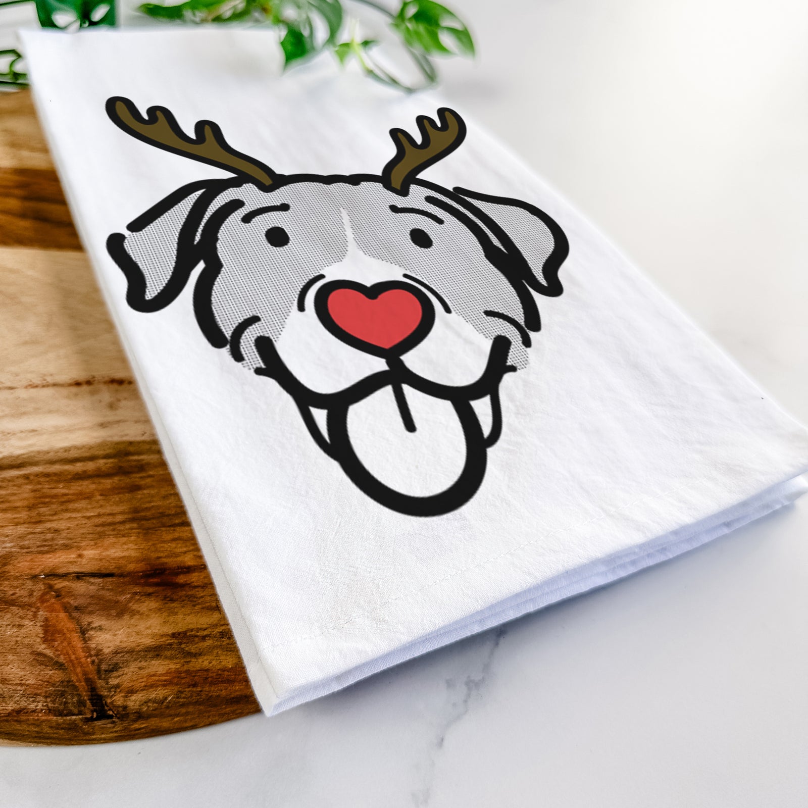 Minimalist line drawing of Shadow the Pitbull Mix with reindeer antlers and a red nose on a tea towel