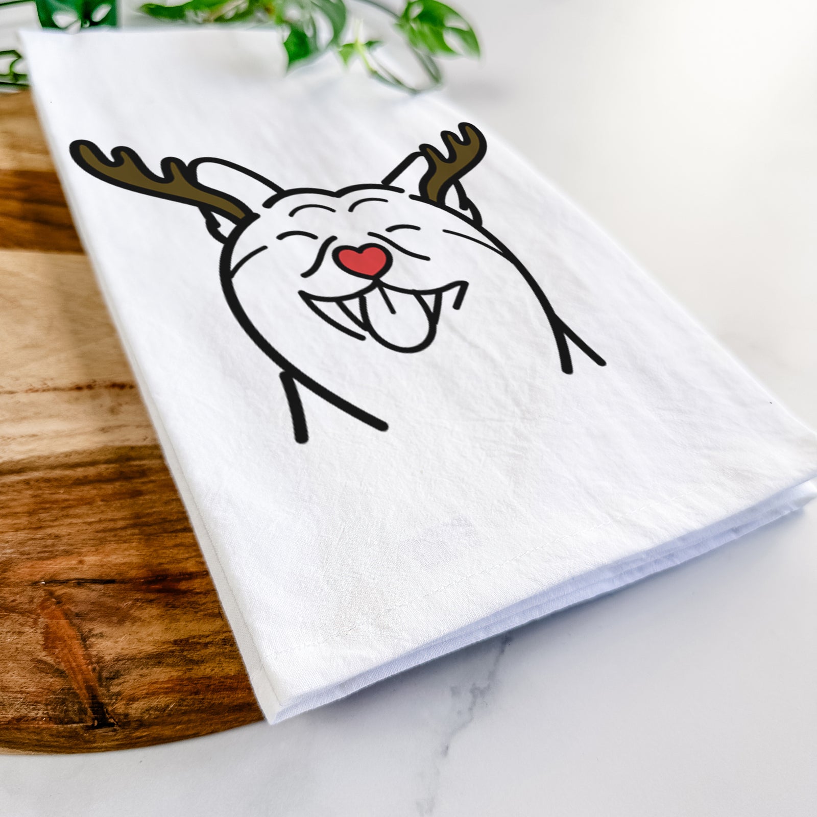 Minimalist line drawing of a Shiba Inu with reindeer antlers and a red nose on a tea towel