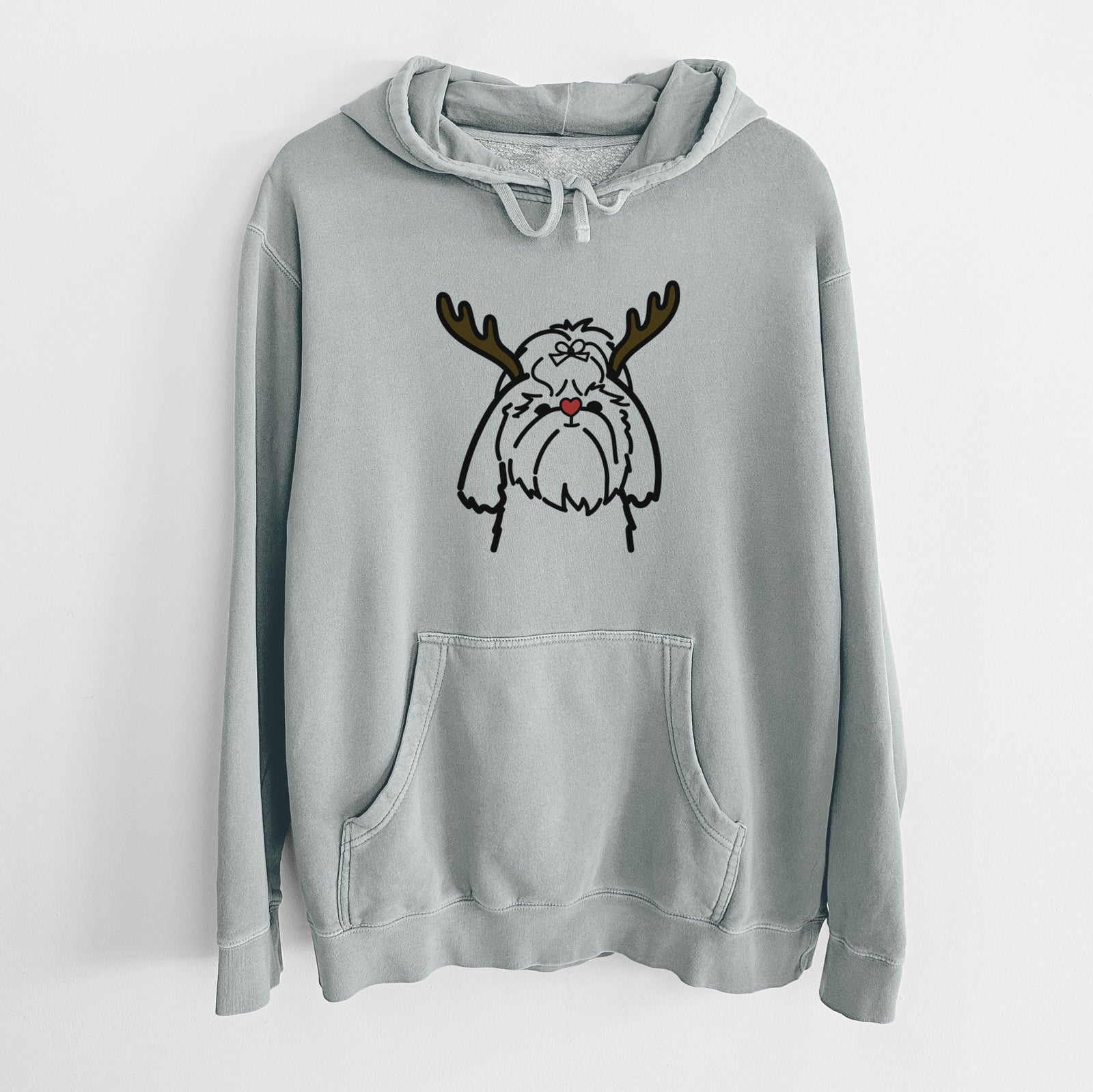 Minimalist line drawing of a Shih Tzu with reindeer antlers and a red nose on a Sage Unisex pigment dyed hoodie