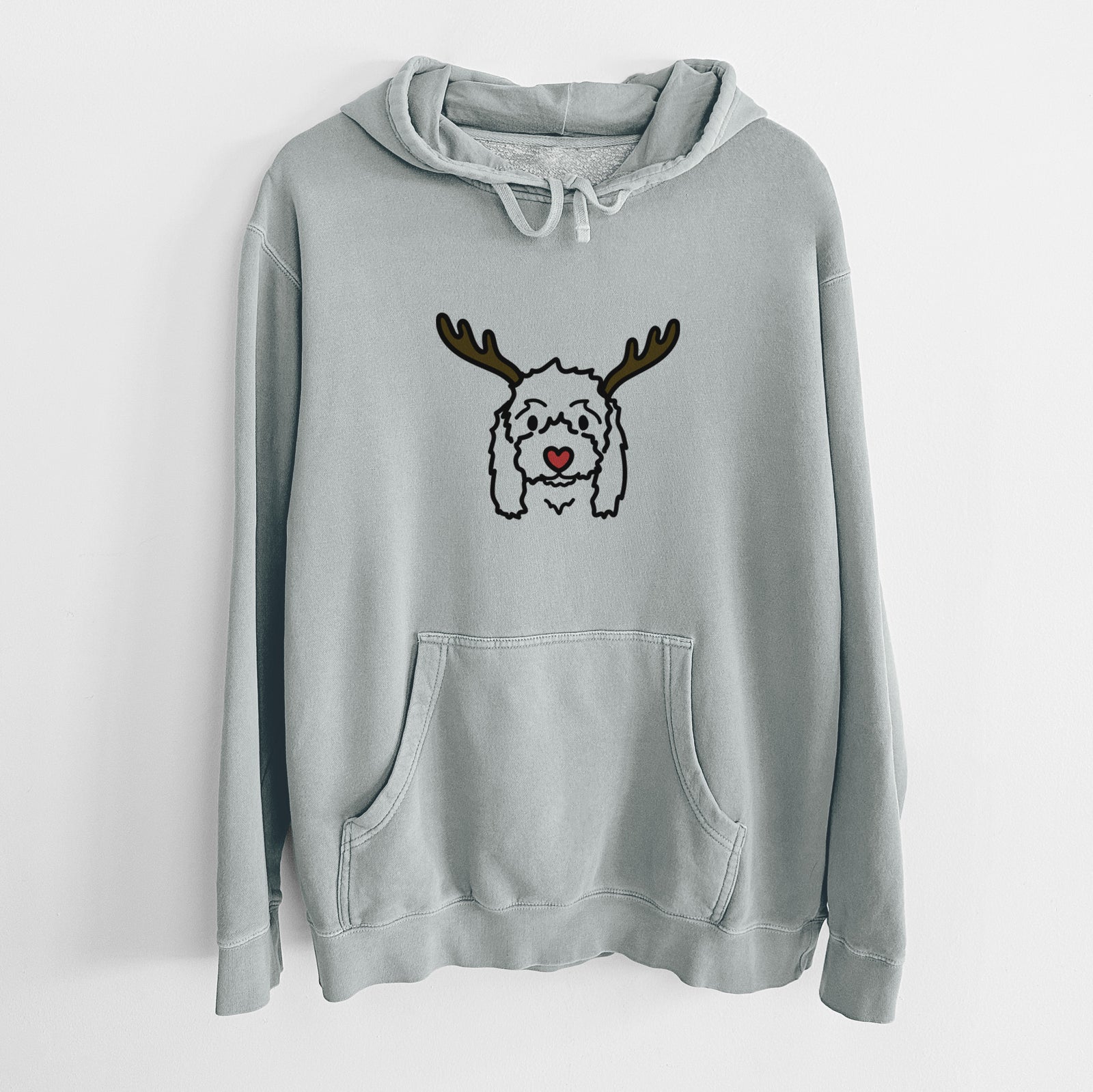 Minimalist line drawing of Sophie the Coton de Tulear with reindeer antlers and a red nose on a Sage Unisex pigment dyed hoodie