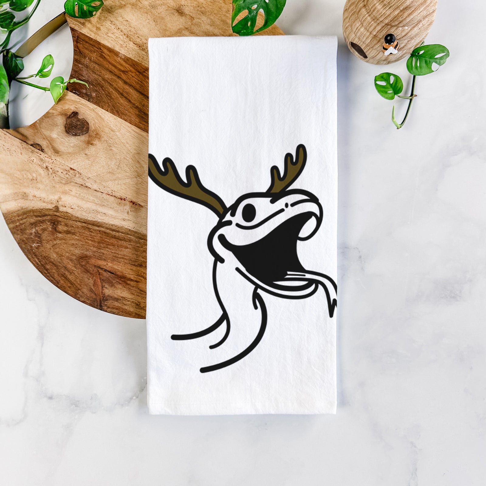 Minimalist line drawing of Spike the Snake with reindeer antlers and a red nose on a tea towel