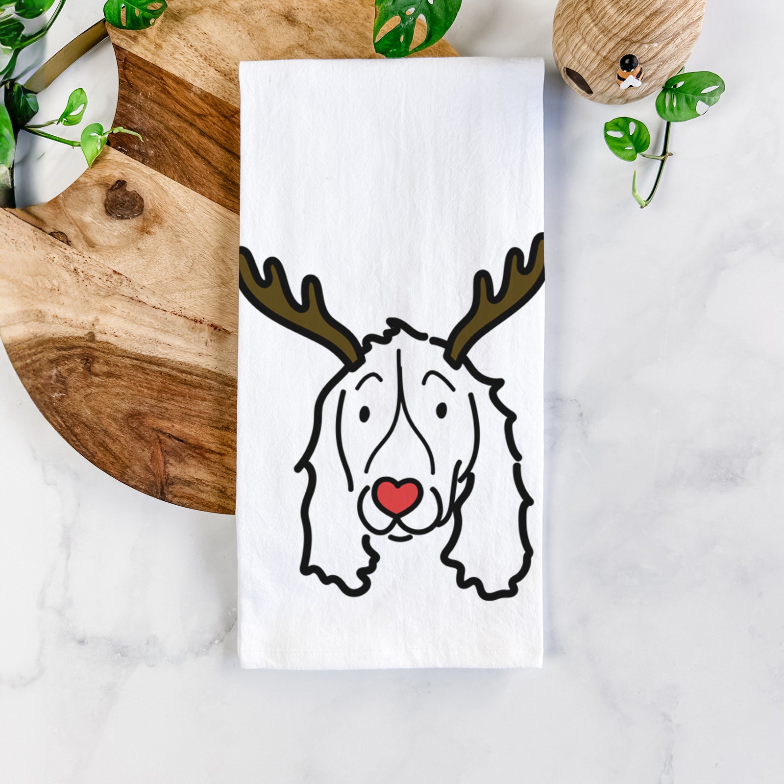 Minimalist line drawing of an English Springer Spaniel with reindeer antlers and a red nose on a tea towel