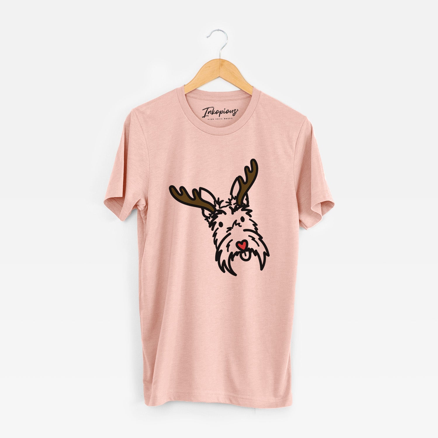 Minimalist line drawing of Thistle the Scottish Terrier with reindeer antlers and a red nose on a Peach Unisex crewneck