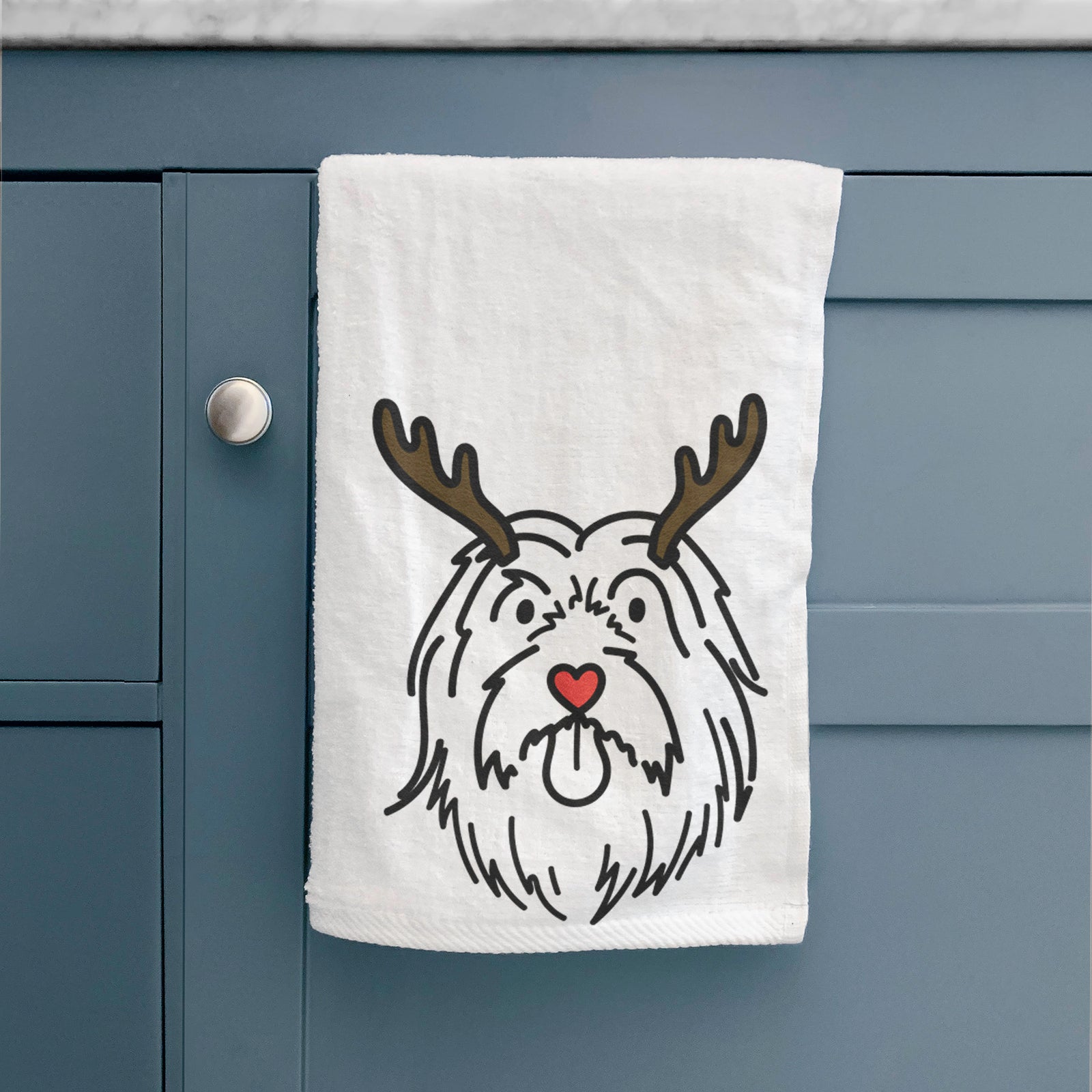 Minimalist line drawing of Tucker the Bearded Collie with reindeer antlers and a red nose on a decorative hand towel
