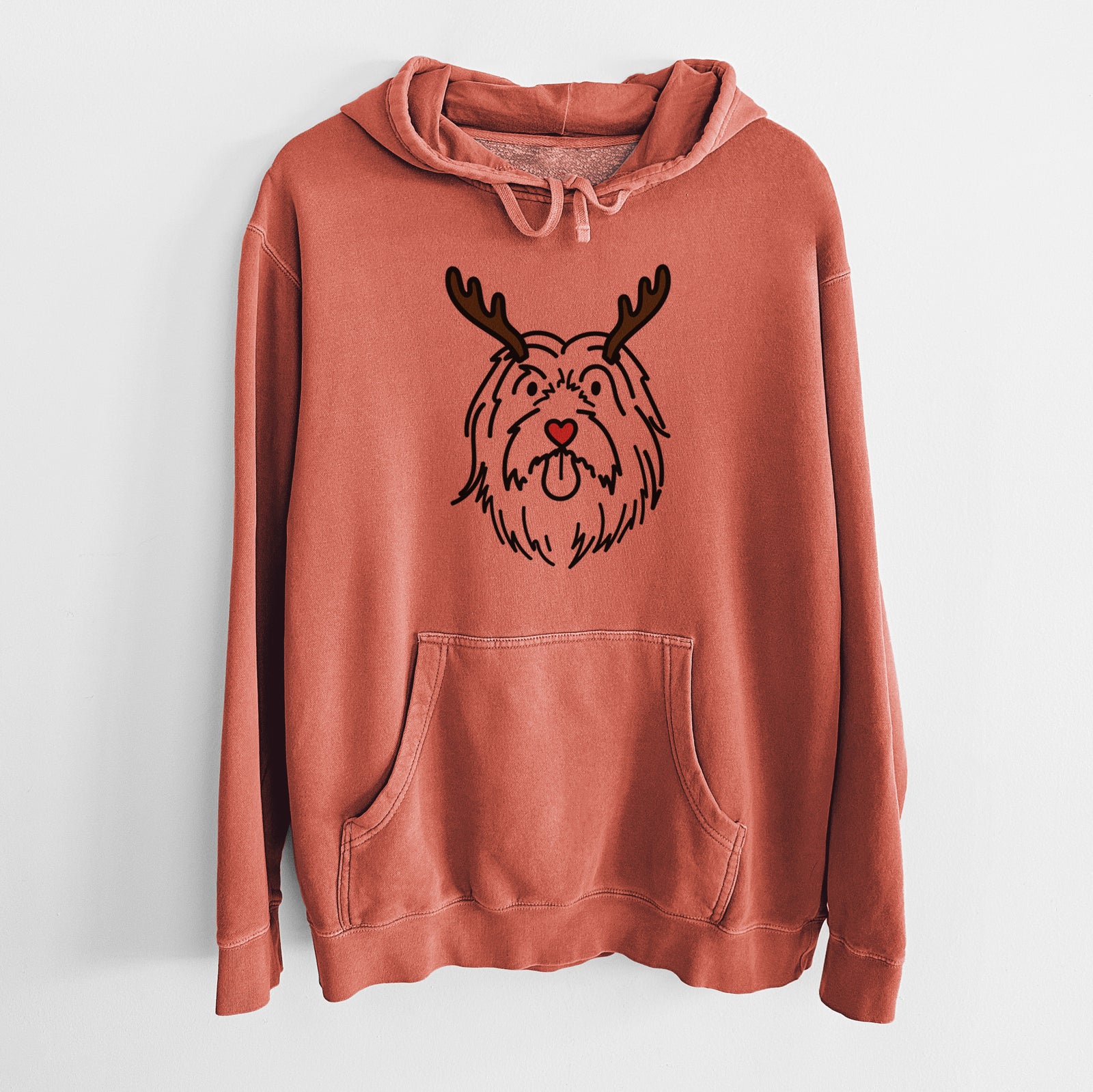 Minimalist line drawing of Tucker the Bearded Collie with reindeer antlers and a red nose on an Amber Unisex pigment dyed hoodie