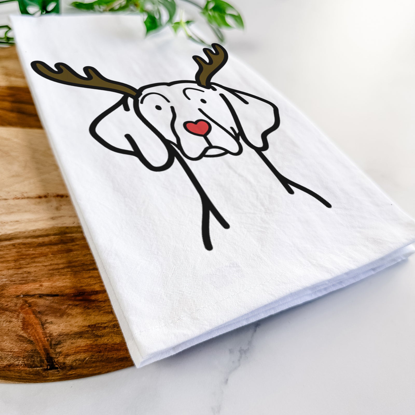 Minimalist line drawing of a Weimaraner with reindeer antlers and a red nose on a tea towel