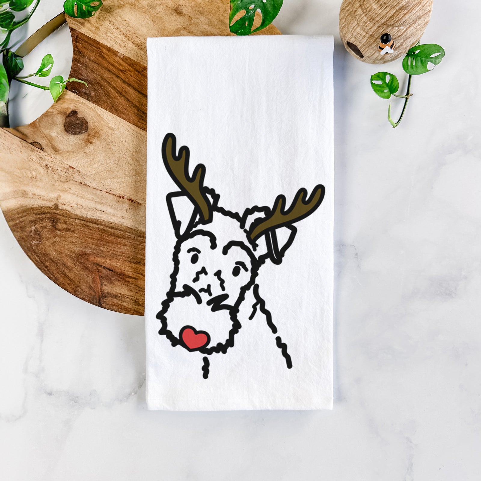 Minimalist line drawing of a Wire Fox Terrier with reindeer antlers and a red nose on a tea towel