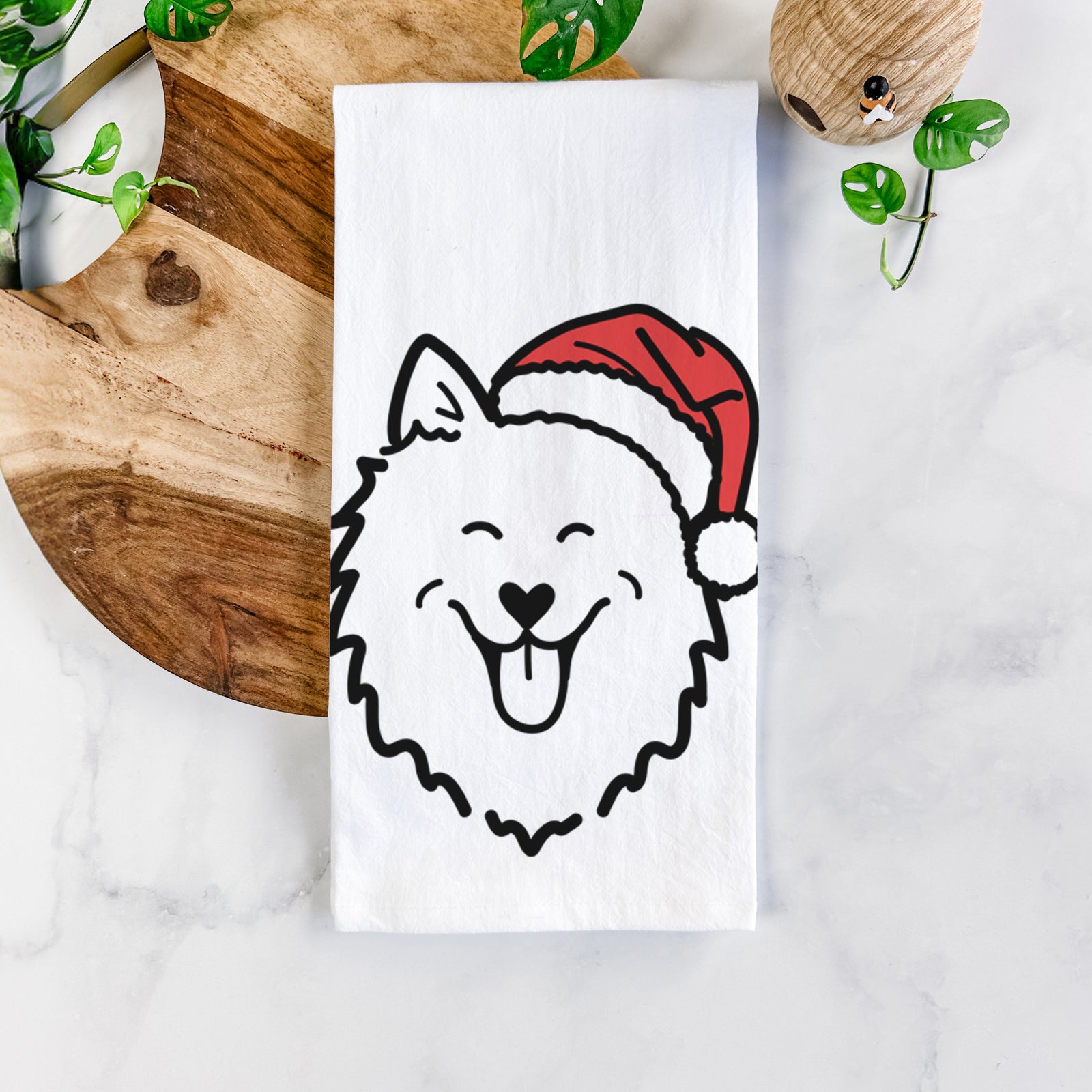 Minimalist line drawing of an American Eskimo wearing a Santa hat on a tea towel