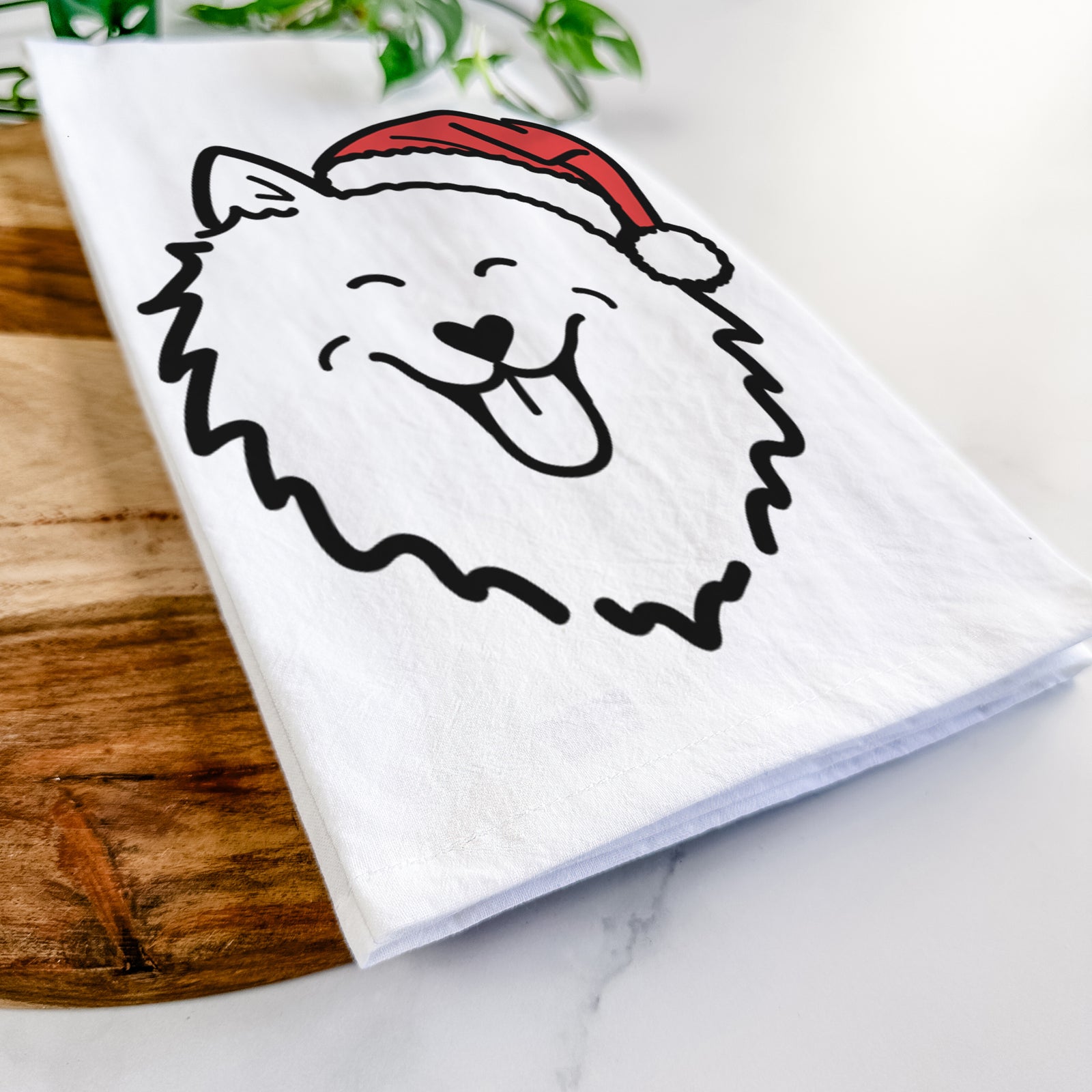 Minimalist line drawing of an American Eskimo wearing a Santa hat on a tea towel