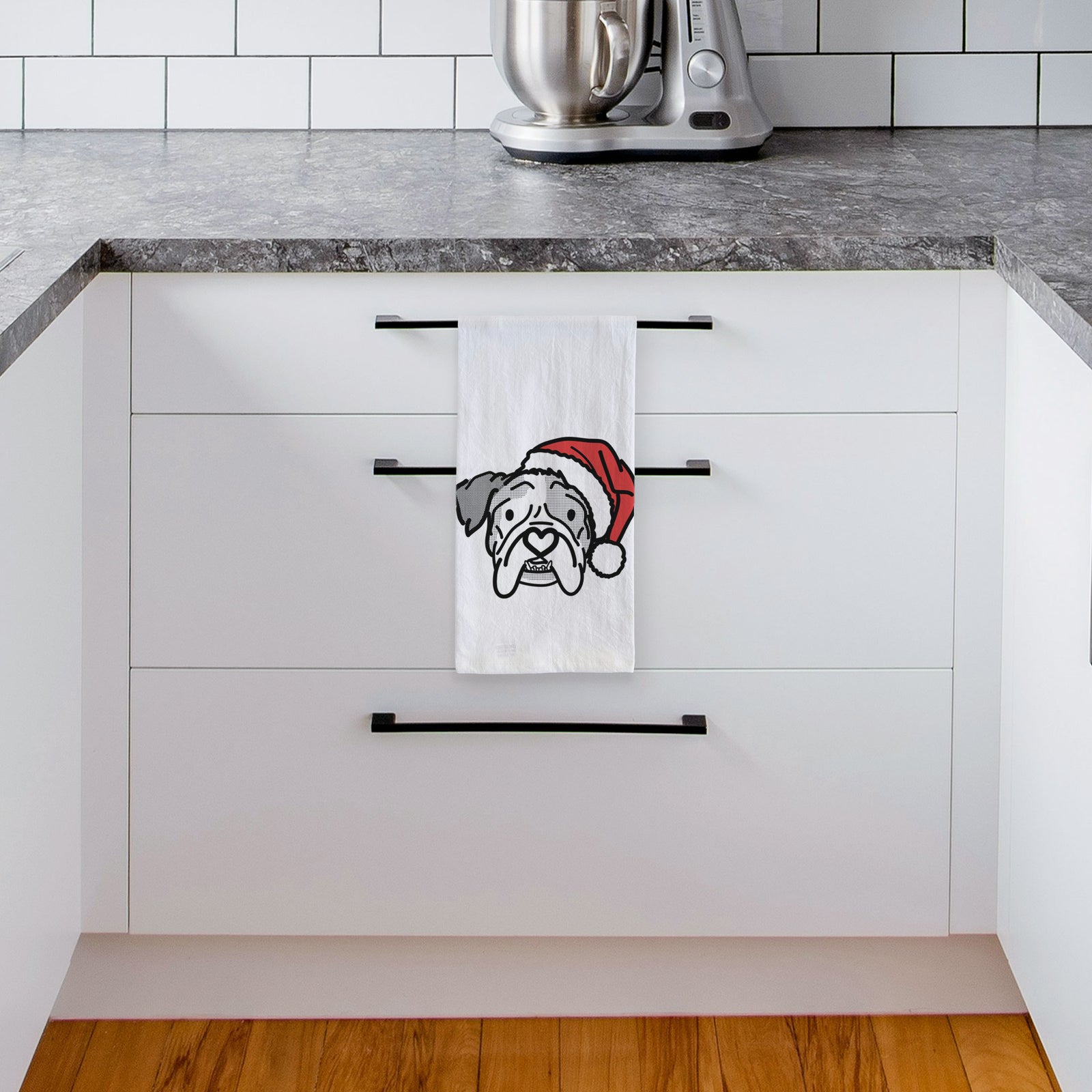 Minimalist line drawing of Bailey the English Bulldog wearing a Santa hat on a tea towel, hanging on an oven door in a kitchen