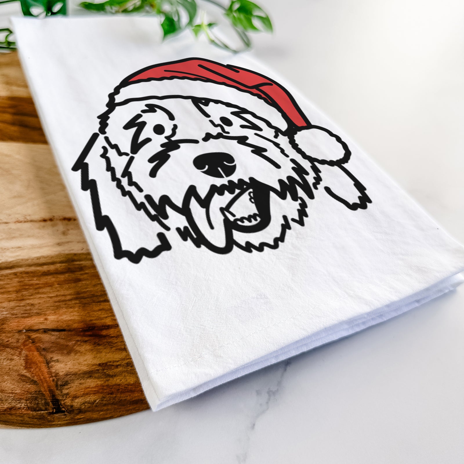 Minimalist line drawing of Barry the Goldendoodle wearing a Santa hat on a tea towel