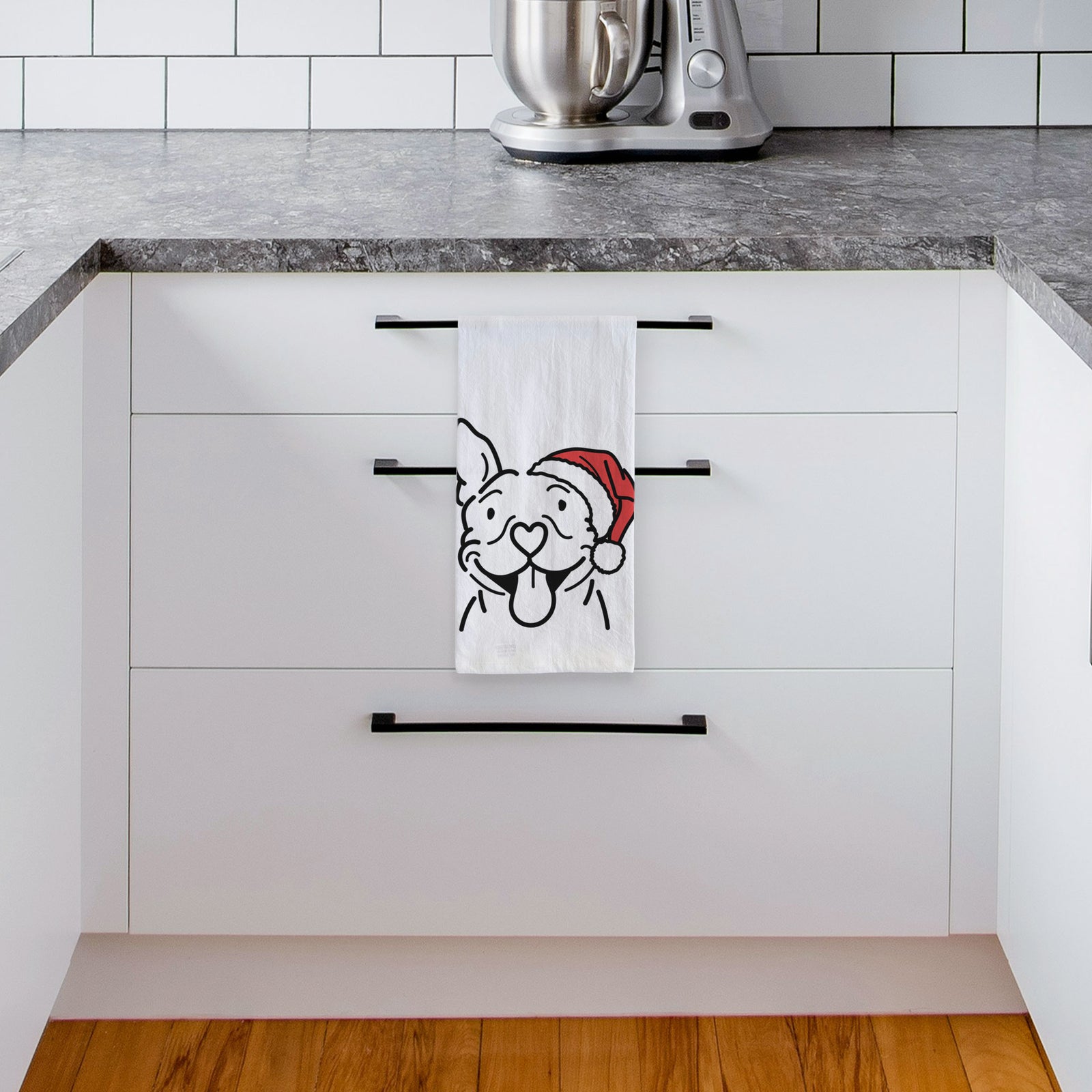Minimalist line drawing of Basil the Pitbull wearing a Santa hat on a tea towel, hanging on an oven door in a kitchen