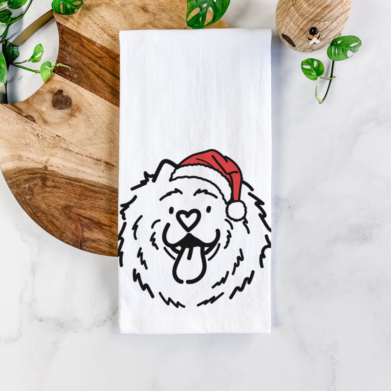 Minimalist line drawing of Bear the Chow Chow wearing a Santa hat on a tea towel