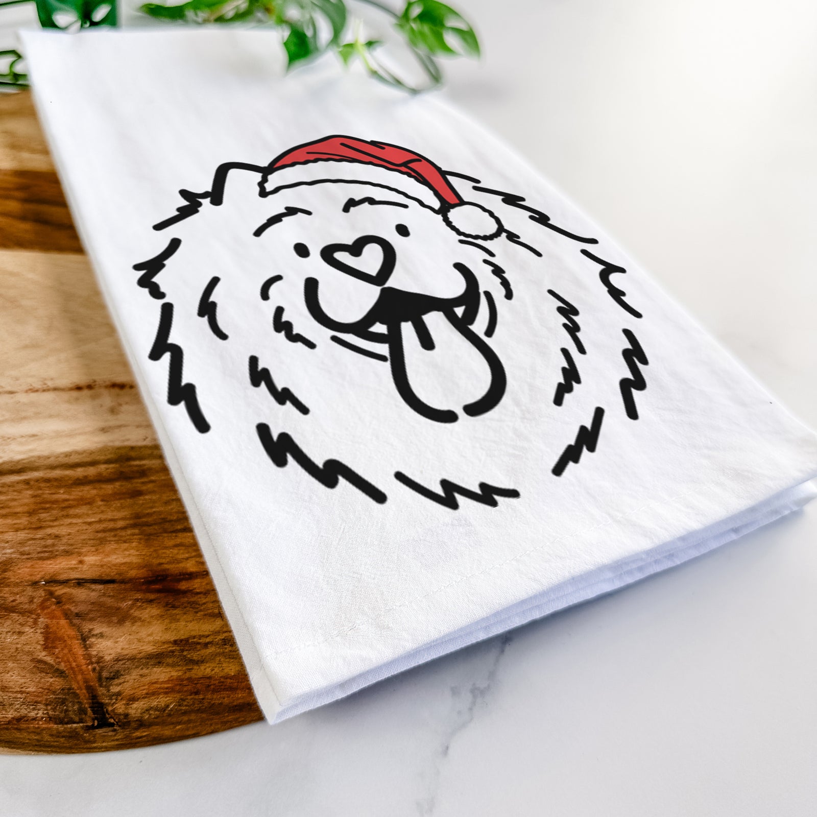 Minimalist line drawing of Bear the Chow Chow wearing a Santa hat on a tea towel