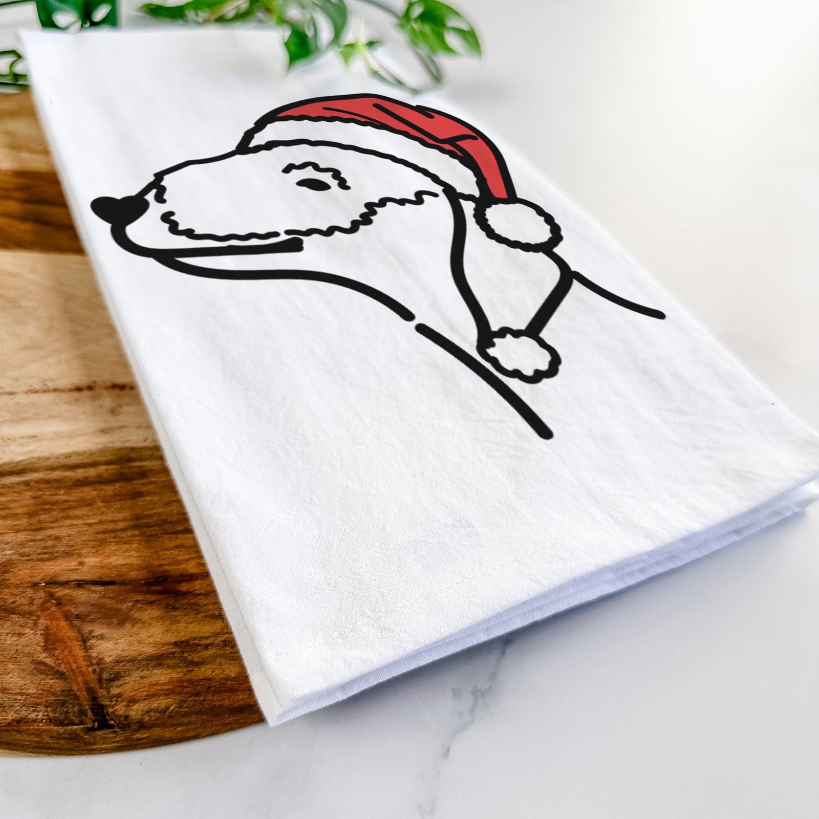 Minimalist line drawing of a Bedlington Terrier wearing a Santa hat on a tea towel