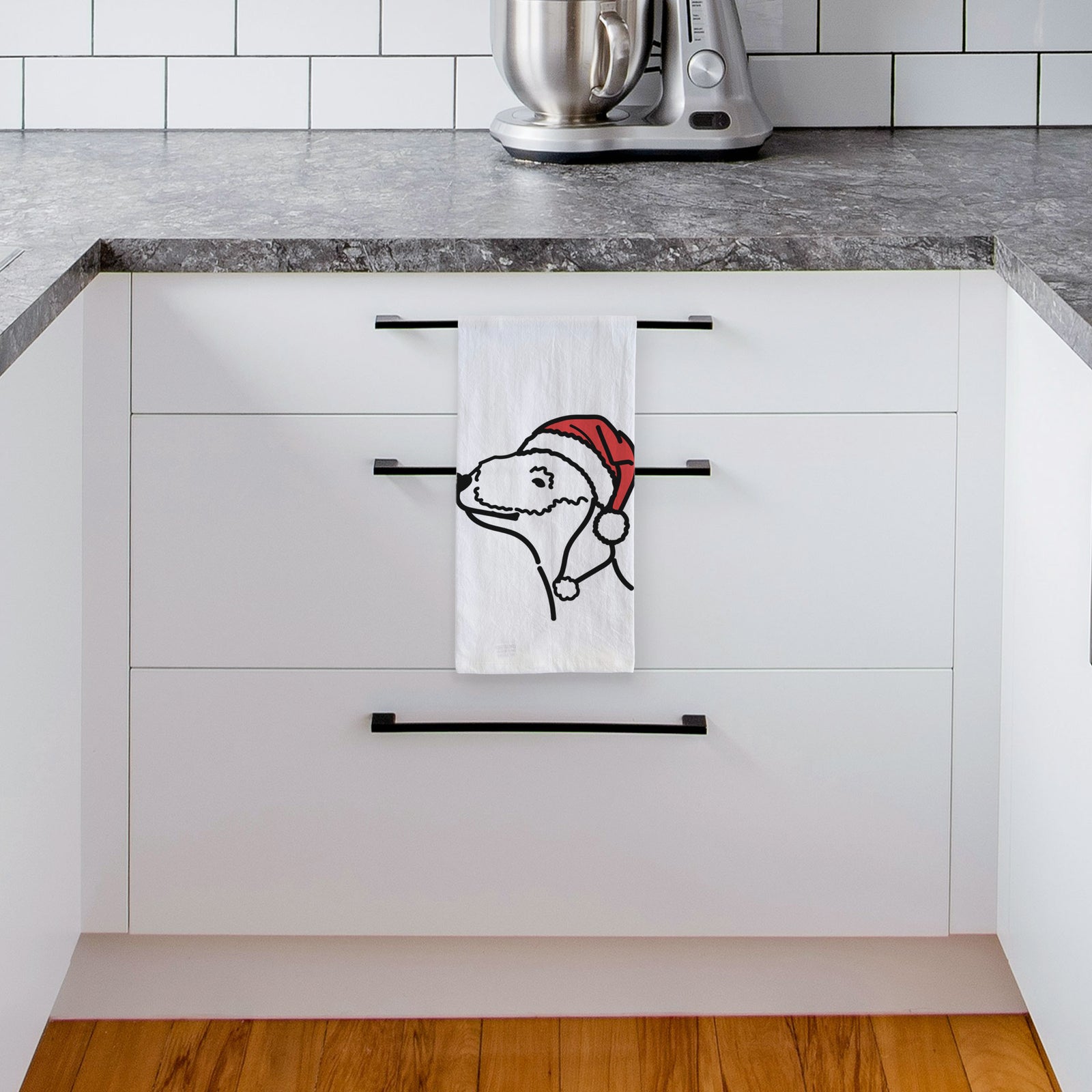 Minimalist line drawing of a Bedlington Terrier wearing a Santa hat on a tea towel, hanging on an oven door in a kitchen
