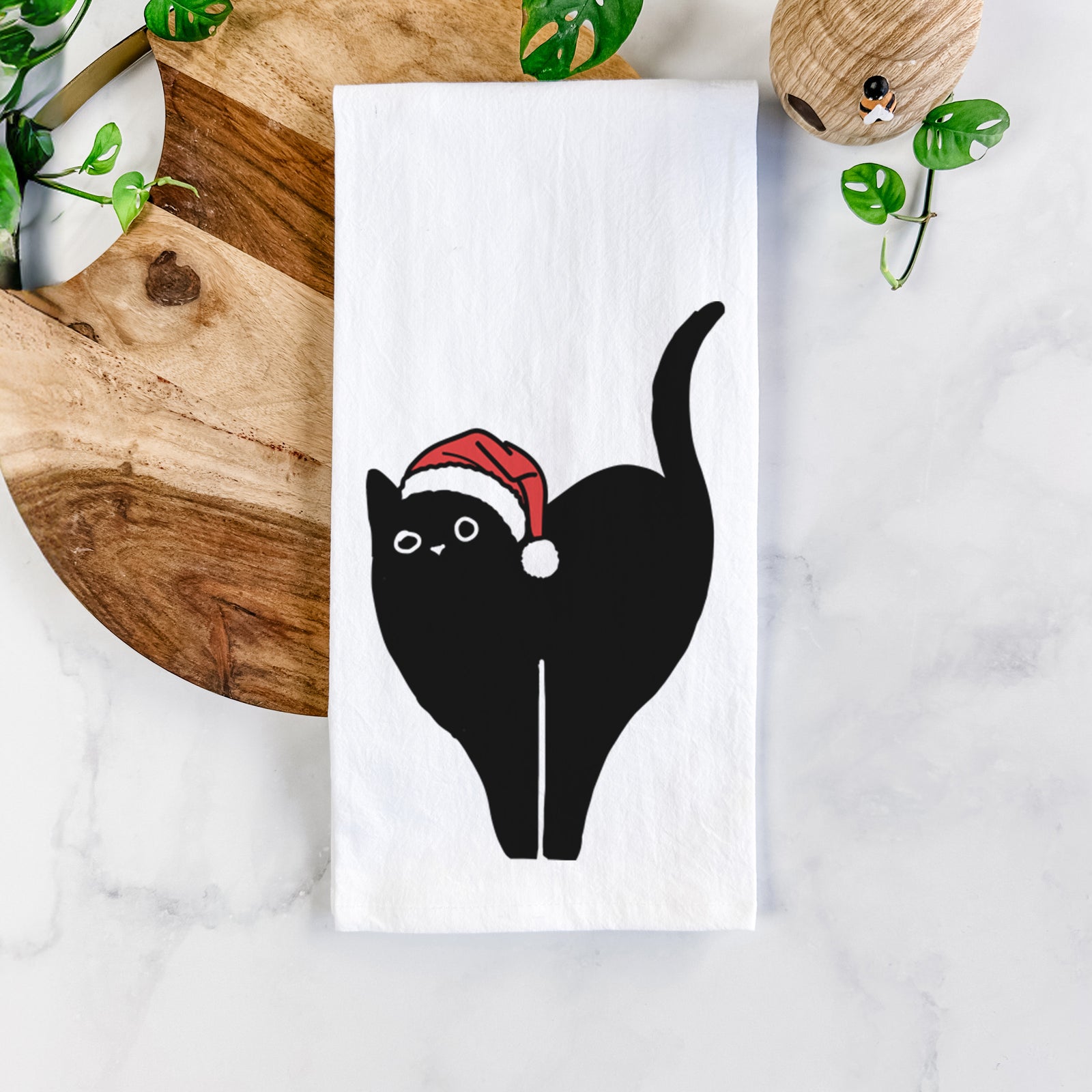 Minimalist line drawing of Bella the Black Cat wearing a Santa hat on a tea towel