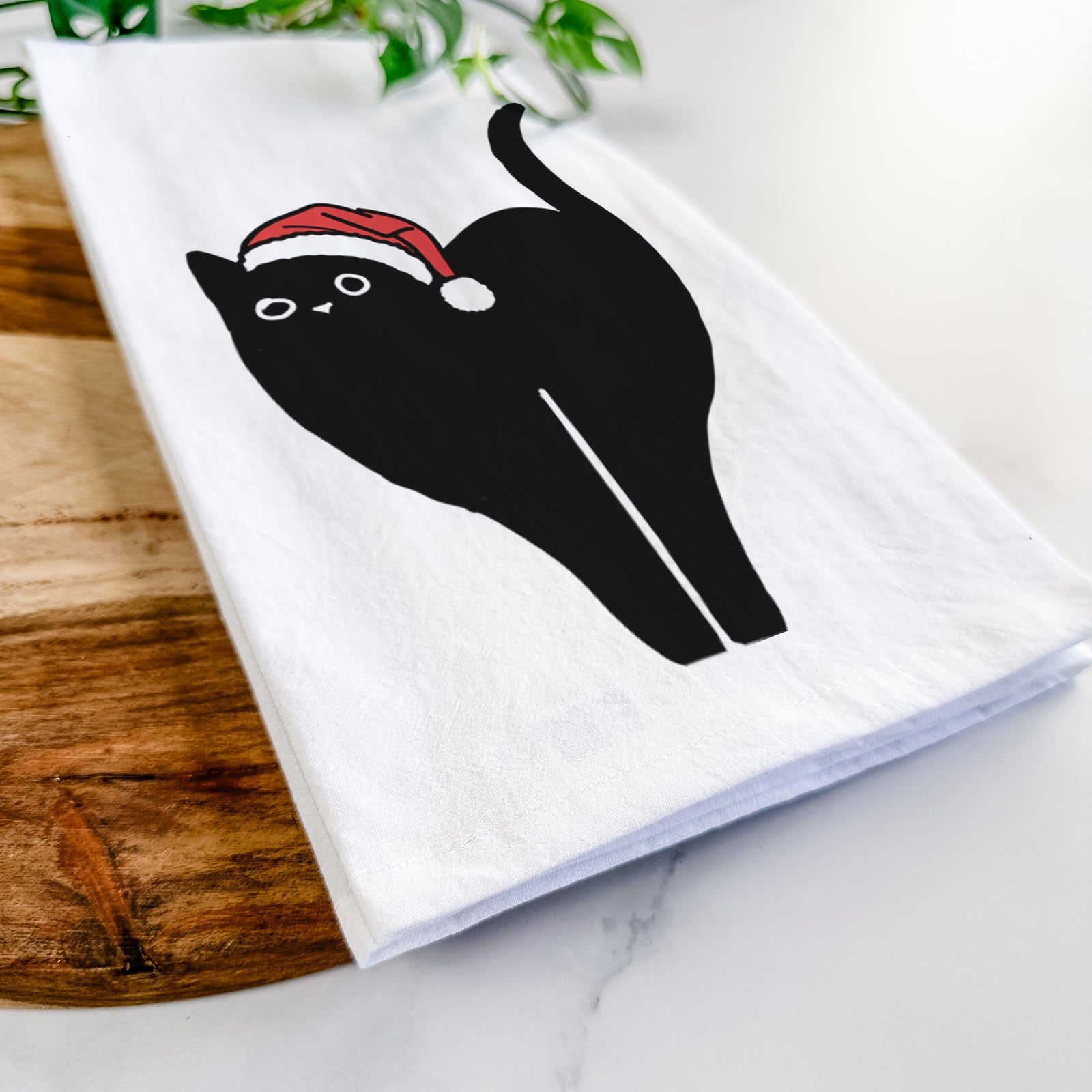 Minimalist line drawing of Bella the Black Cat wearing a Santa hat on a tea towel