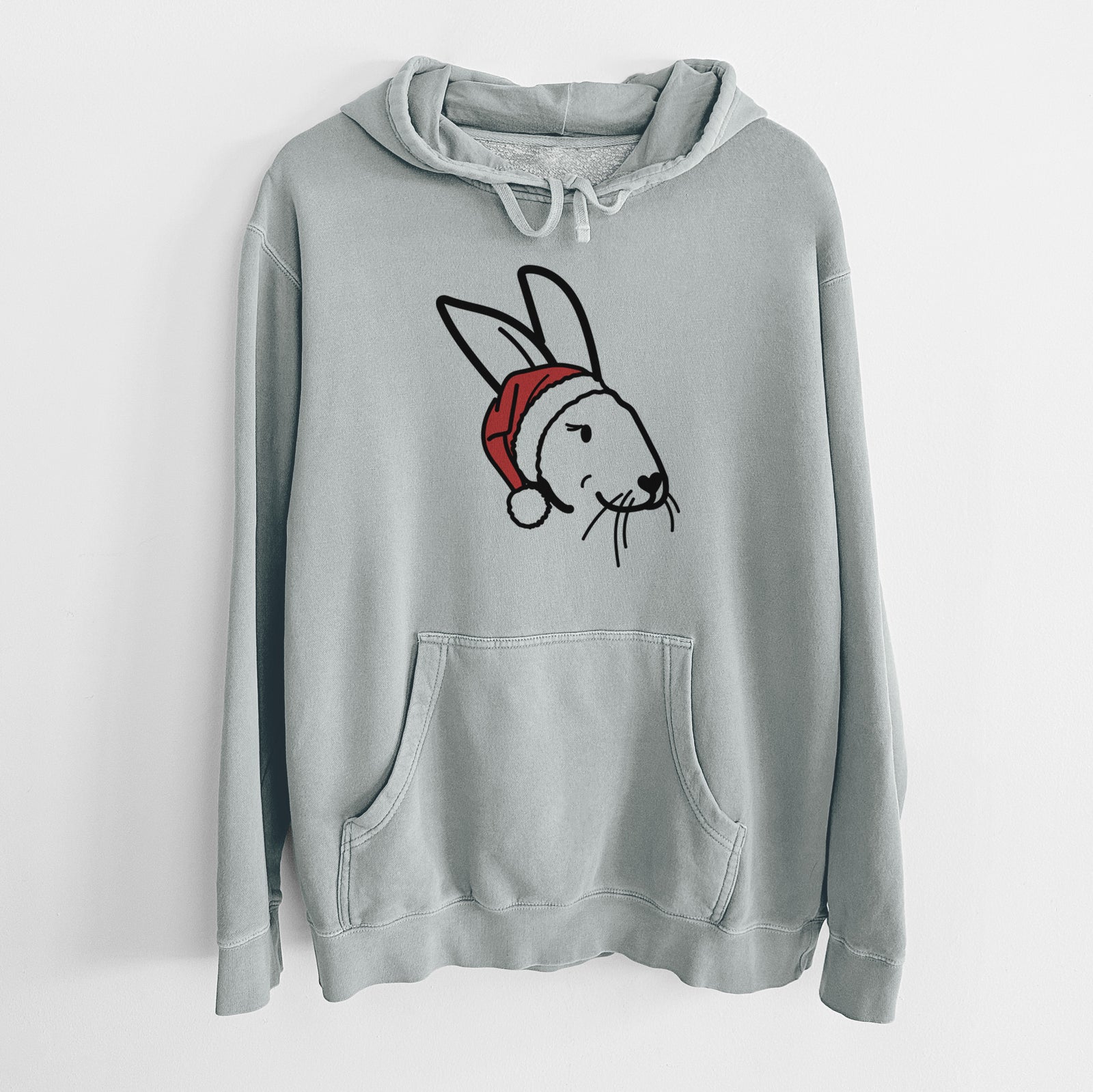 Minimalist line drawing of Betsy the Rex Rabbit wearing a Santa hat on a Sage Unisex pigment dyed hoodie