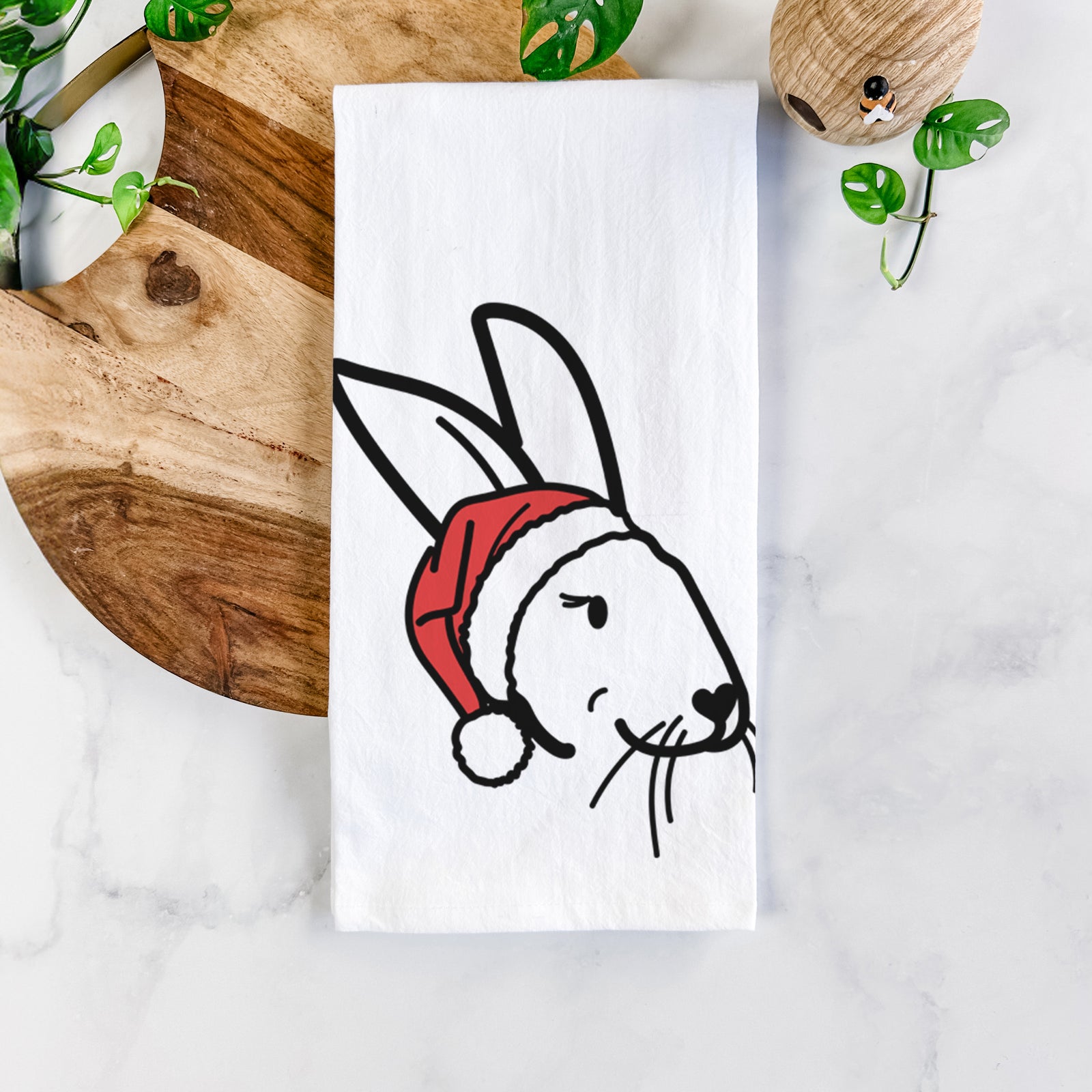 Minimalist line drawing of Betsy the Rex Rabbit wearing a Santa hat on a tea towel