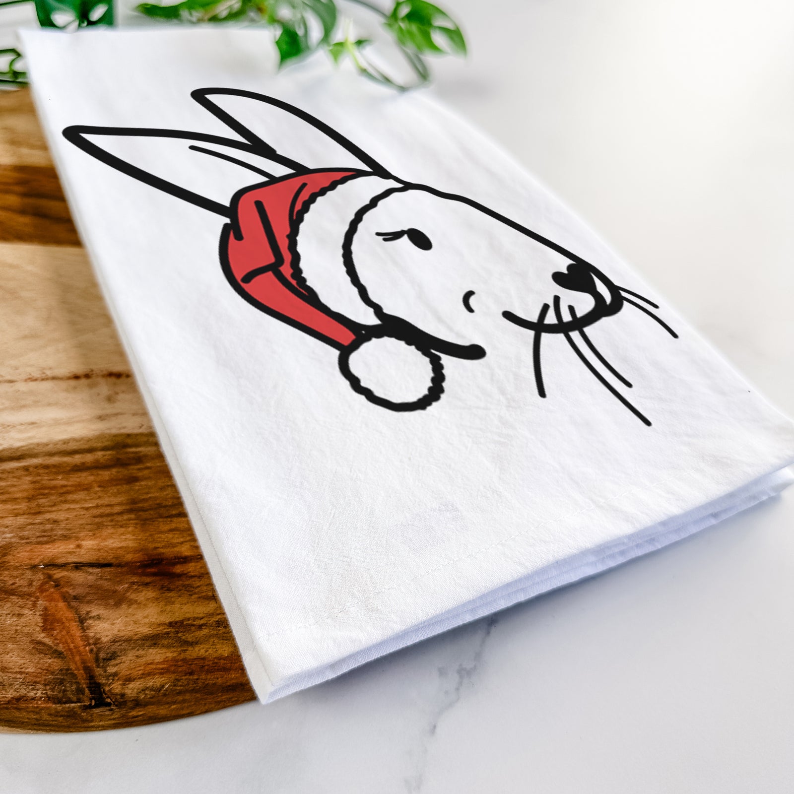 Minimalist line drawing of Betsy the Rex Rabbit wearing a Santa hat on a tea towel