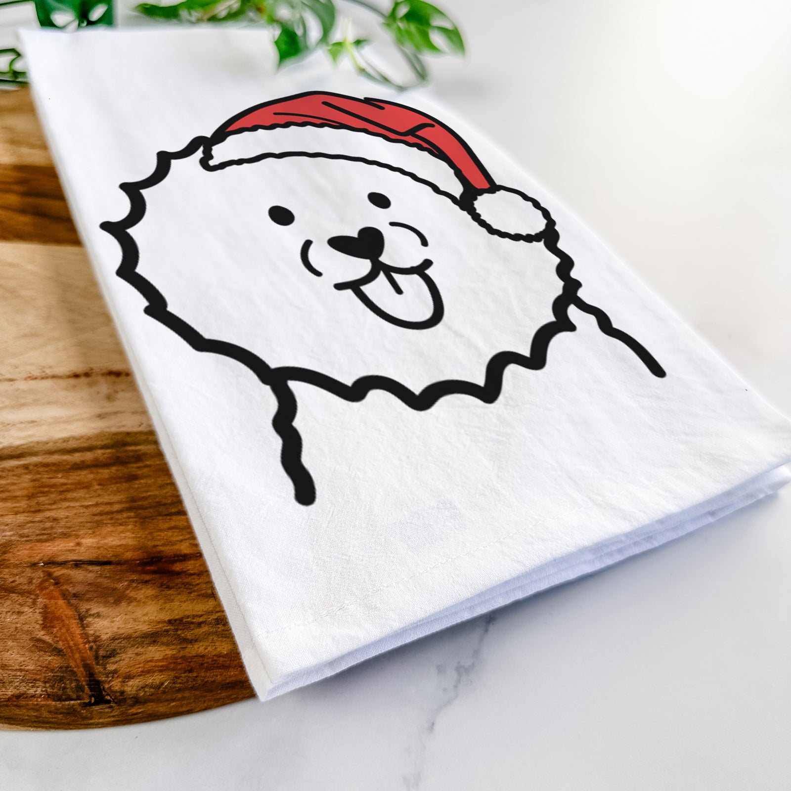 Minimalist line drawing of a Bichon Frise wearing a Santa hat on a tea towel