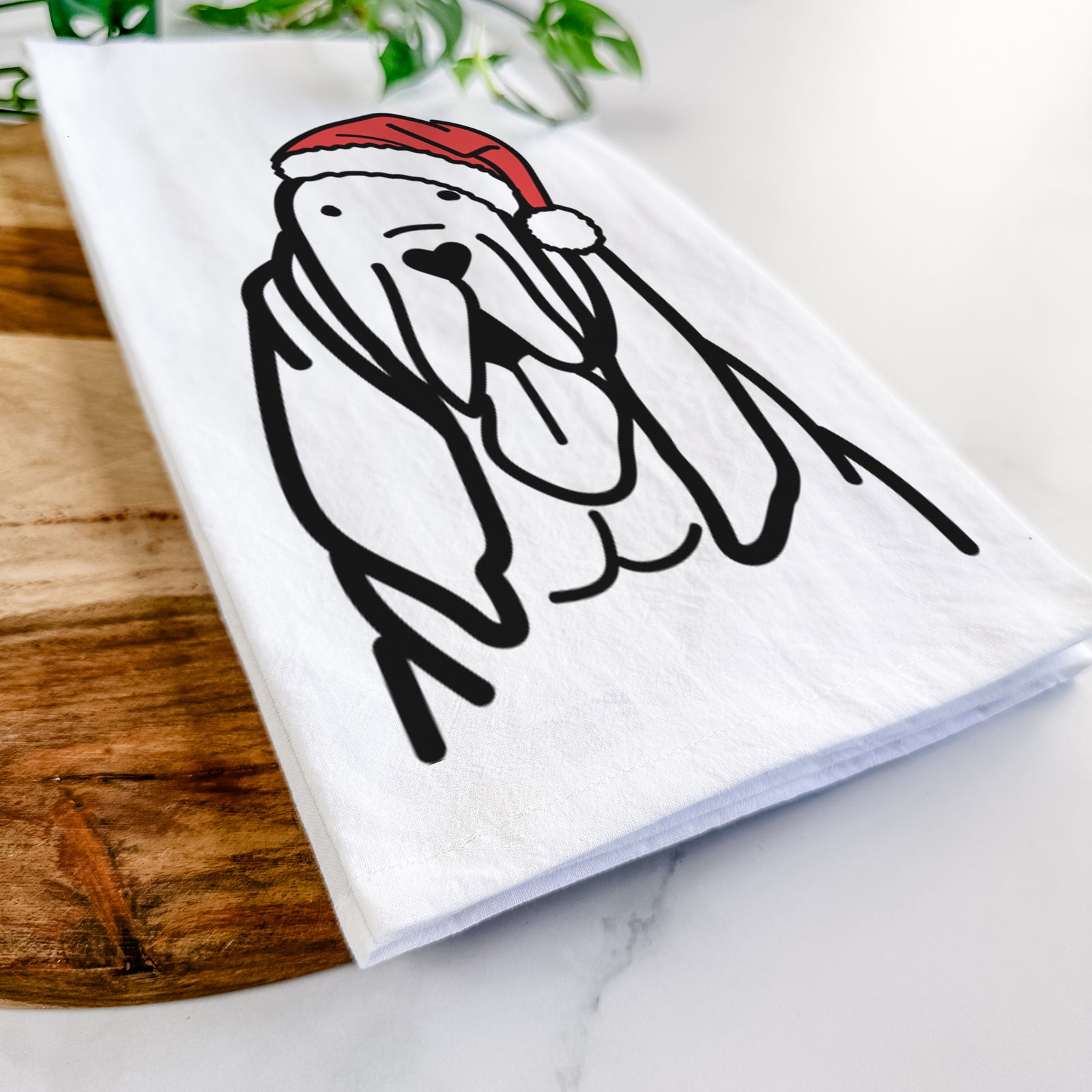 Minimalist line drawing of a Bloodhound wearing a Santa hat on a tea towel