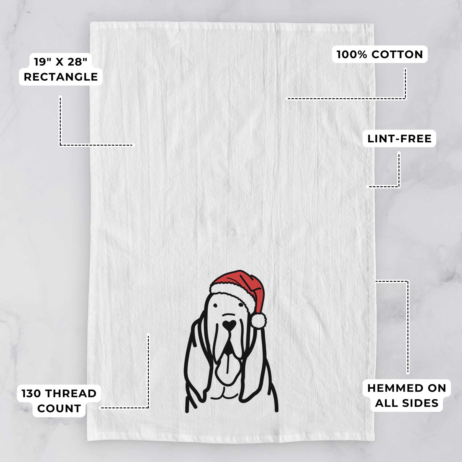 Minimalist line drawing of a Bloodhound wearing a Santa hat on a tea towel, with feature callouts: 19 x 28 inch rectangle, 100% cotton, lint-free, 120 thread count, hemmed on all sides