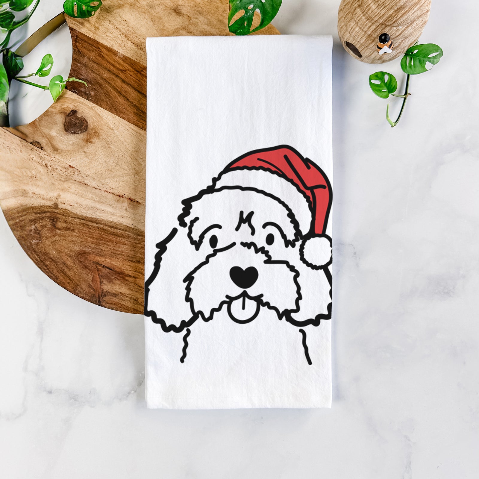 Minimalist line drawing of a Cavapoo wearing a Santa hat on a tea towel