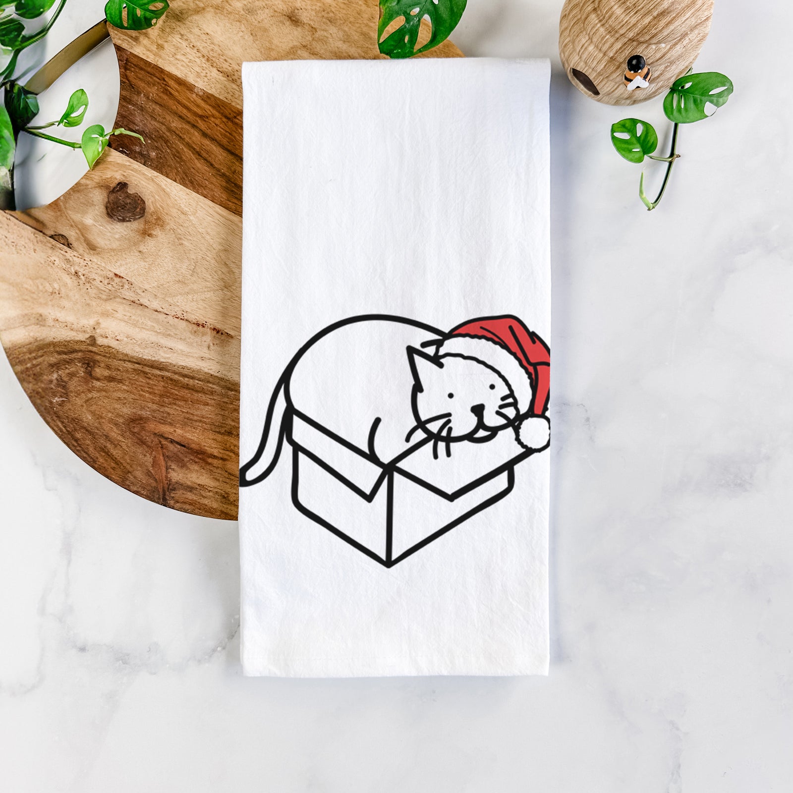 Minimalist line drawing of Charlie the Cat in a Box wearing a Santa hat on a tea towel