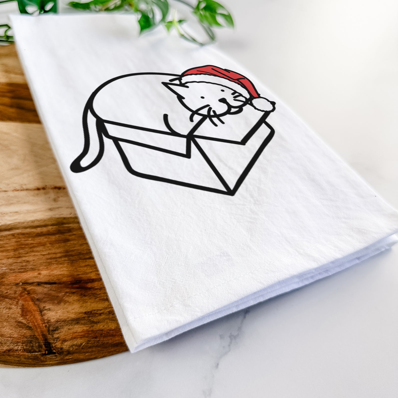 Minimalist line drawing of Charlie the Cat in a Box wearing a Santa hat on a tea towel