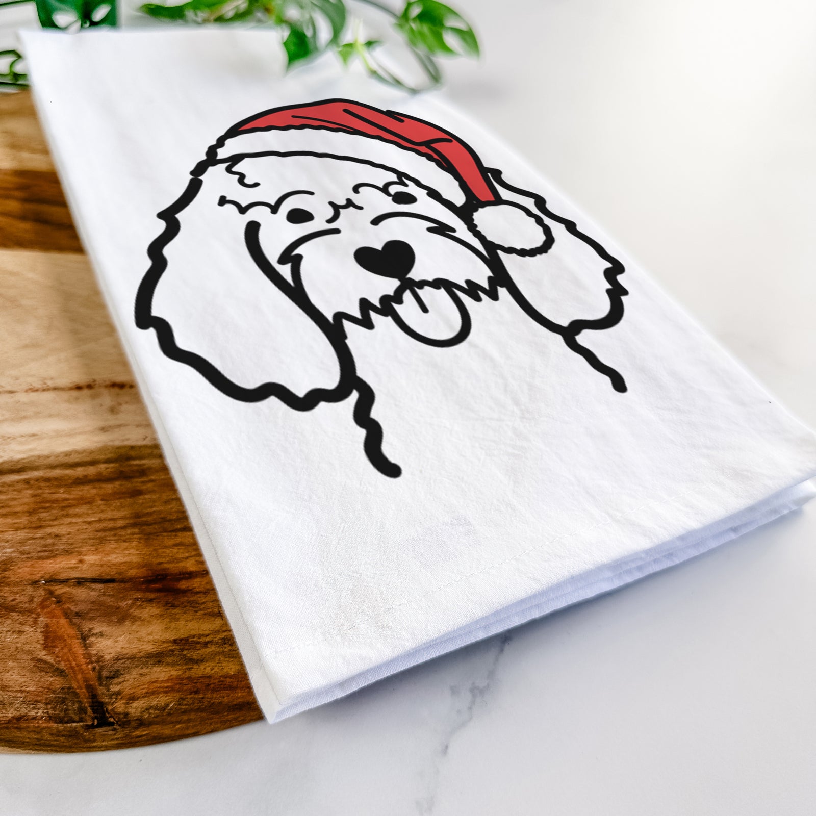 Minimalist line drawing of a Cockapoo wearing a Santa hat on a tea towel