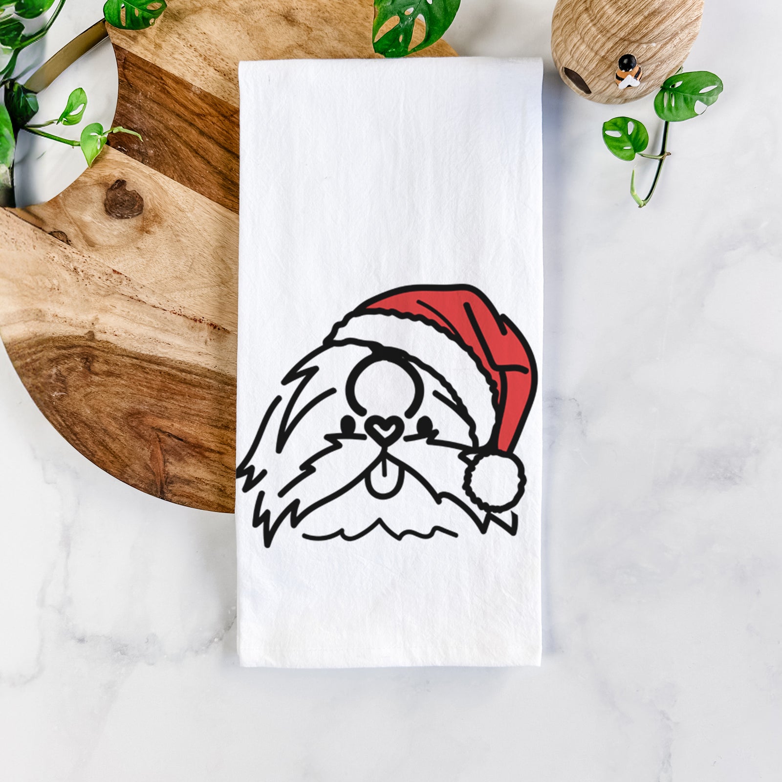Minimalist line drawing of CoCo the Shih Tzu wearing a Santa hat on a tea towel