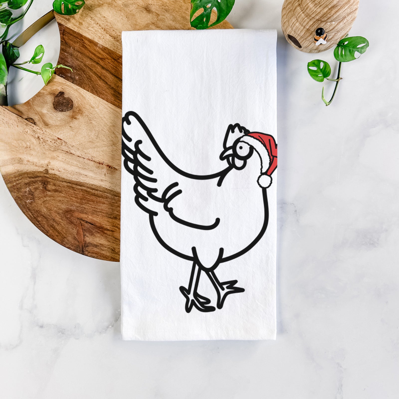Minimalist line drawing of Daisy the Chicken wearing a Santa hat on a tea towel