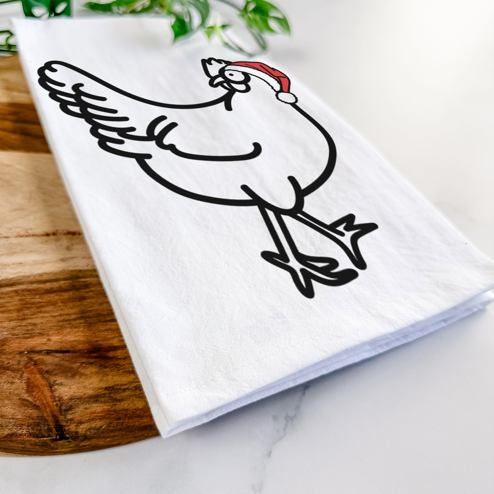 Minimalist line drawing of Daisy the Chicken wearing a Santa hat on a tea towel